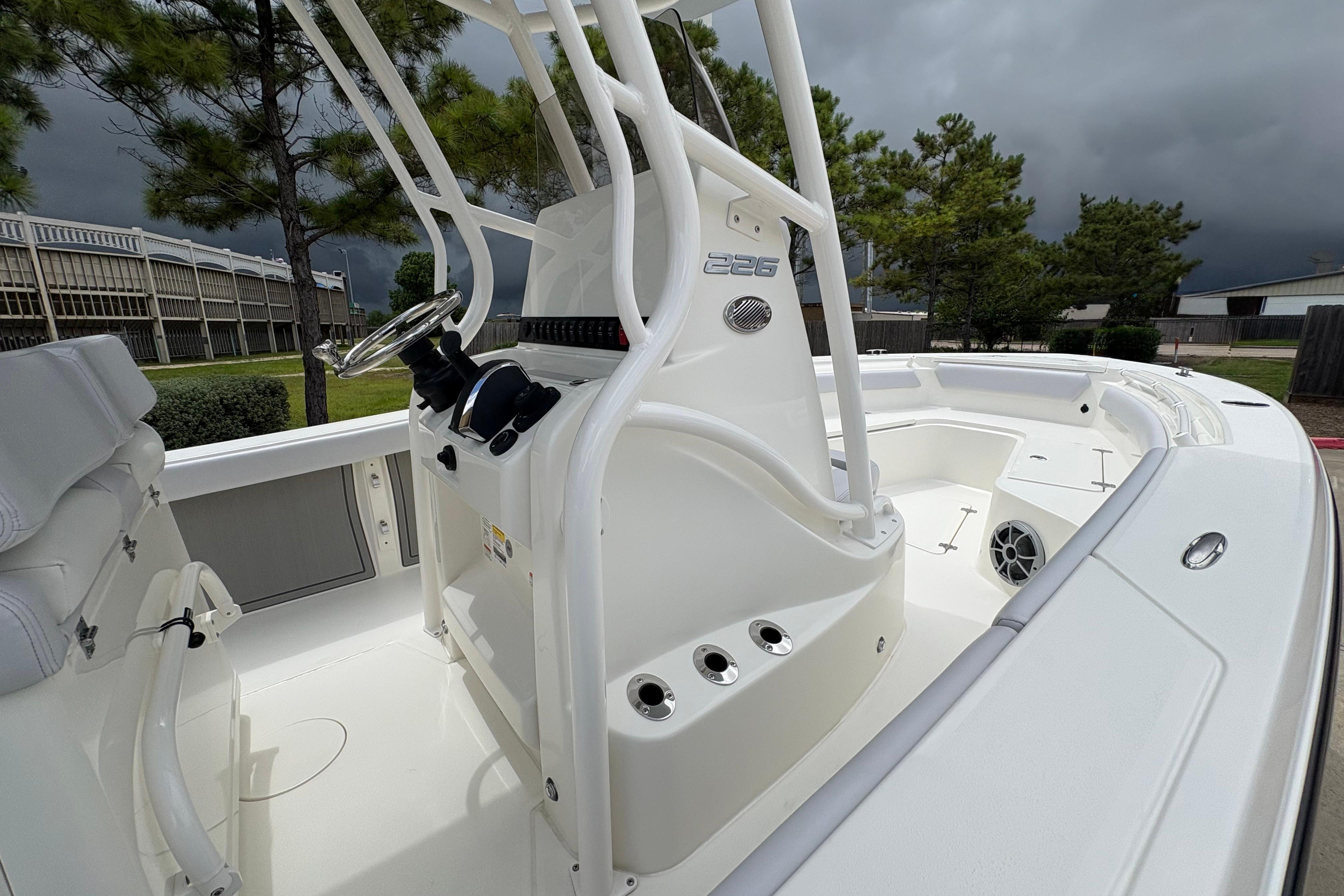 2026 Mako 226 Center Console boat with sleek white design and modern controls.