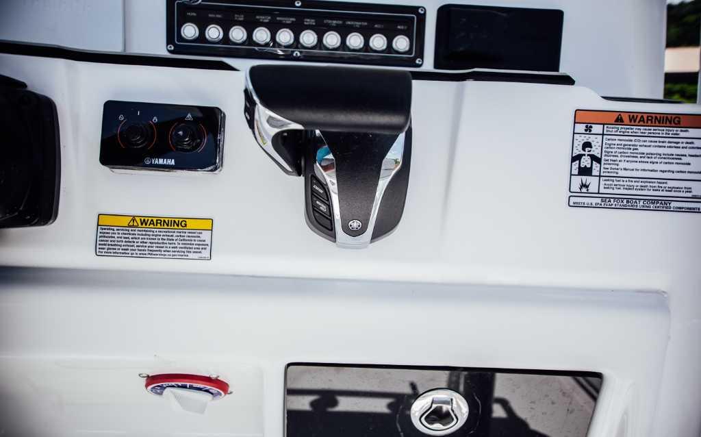 Control panel of 2021 Sea Fox 248 Commander boat with Yamaha throttle and warning labels.