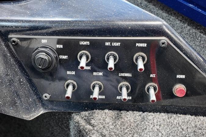 Control panel of a 2024 Lowe Stinger 198 boat with various switches.