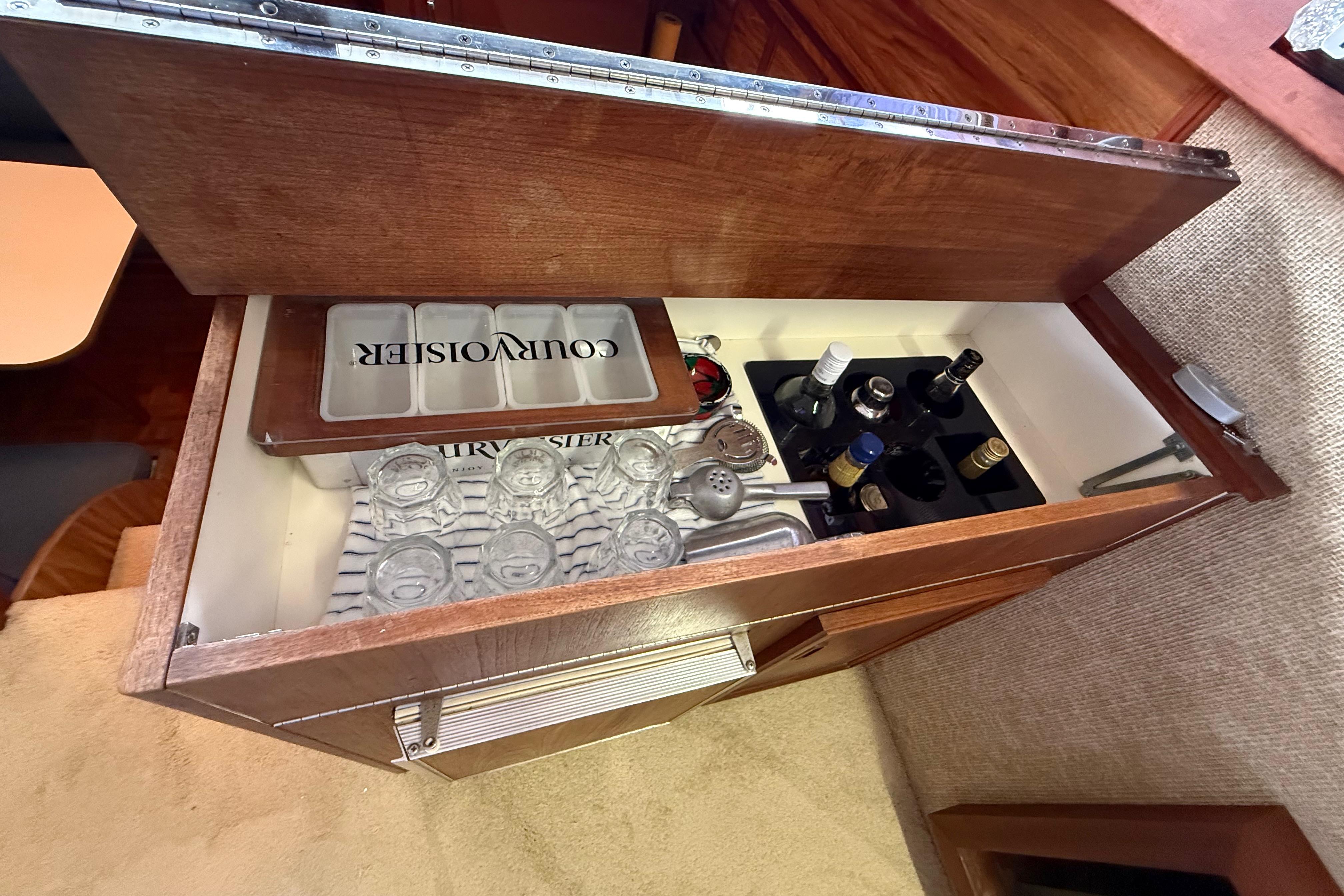 Bar cabinet with glassware and bottles in a 1979 Viking 43 Double Cabin yacht.