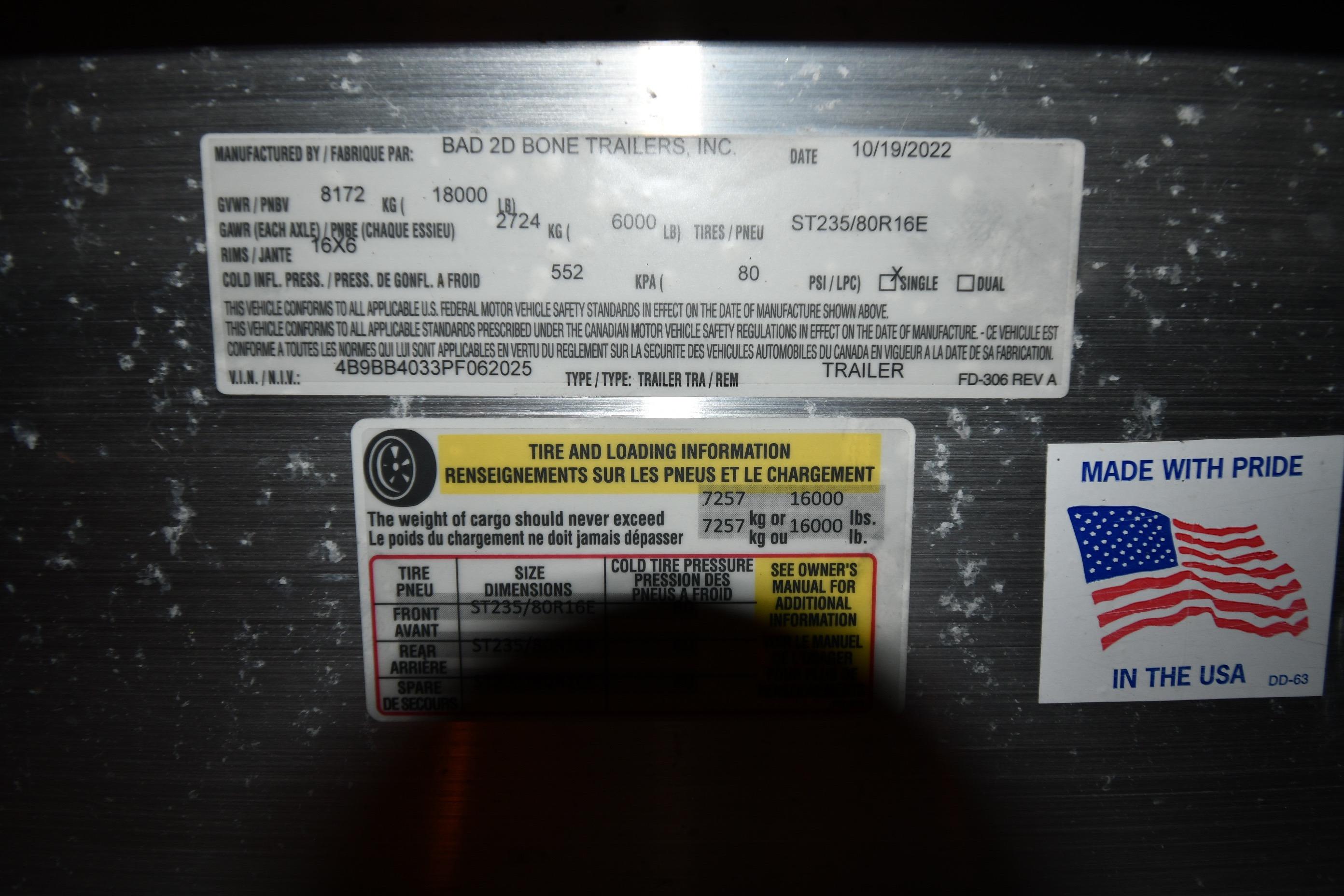 Trailer information labels with tire and loading details, featuring an American flag sticker.