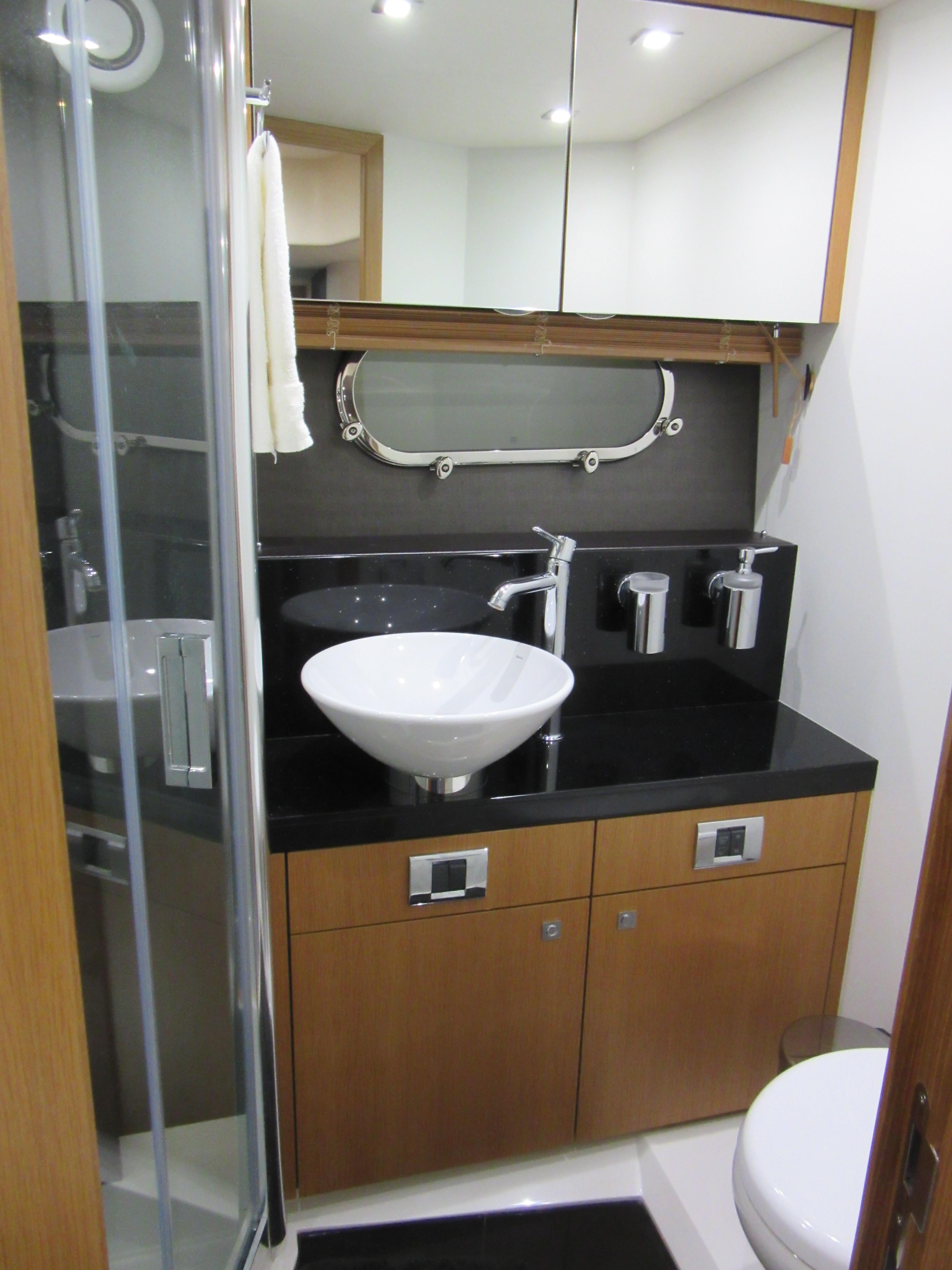 Luxurious bathroom in 2014 Sunseeker Manhattan 53 yacht with modern fixtures and sleek design.