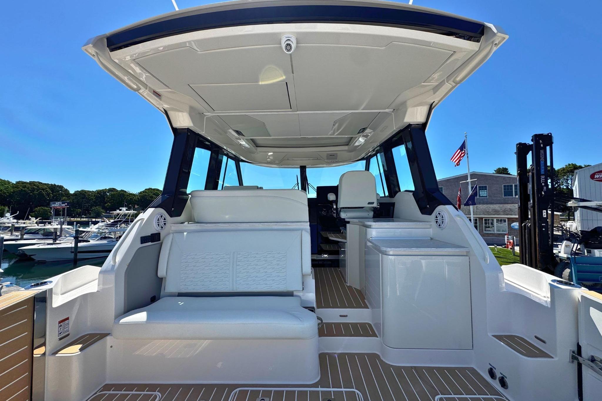 2027 Tiara Yachts 39 LE interior with seating and helm, docked at marina.
