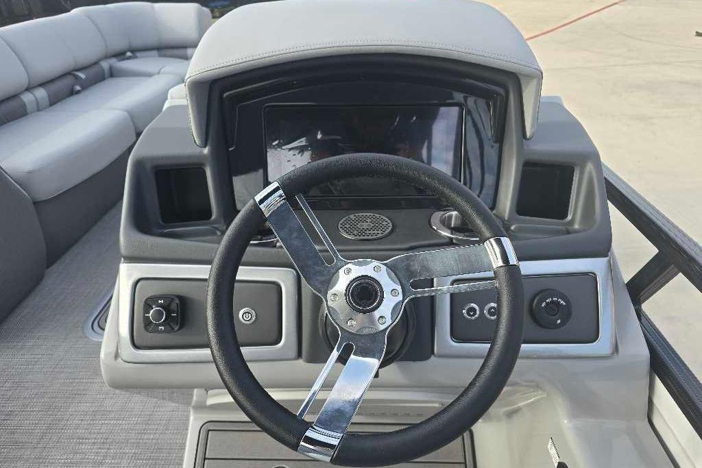 2025 Regency 250 LE3 Sport boat dashboard with steering wheel and controls.
