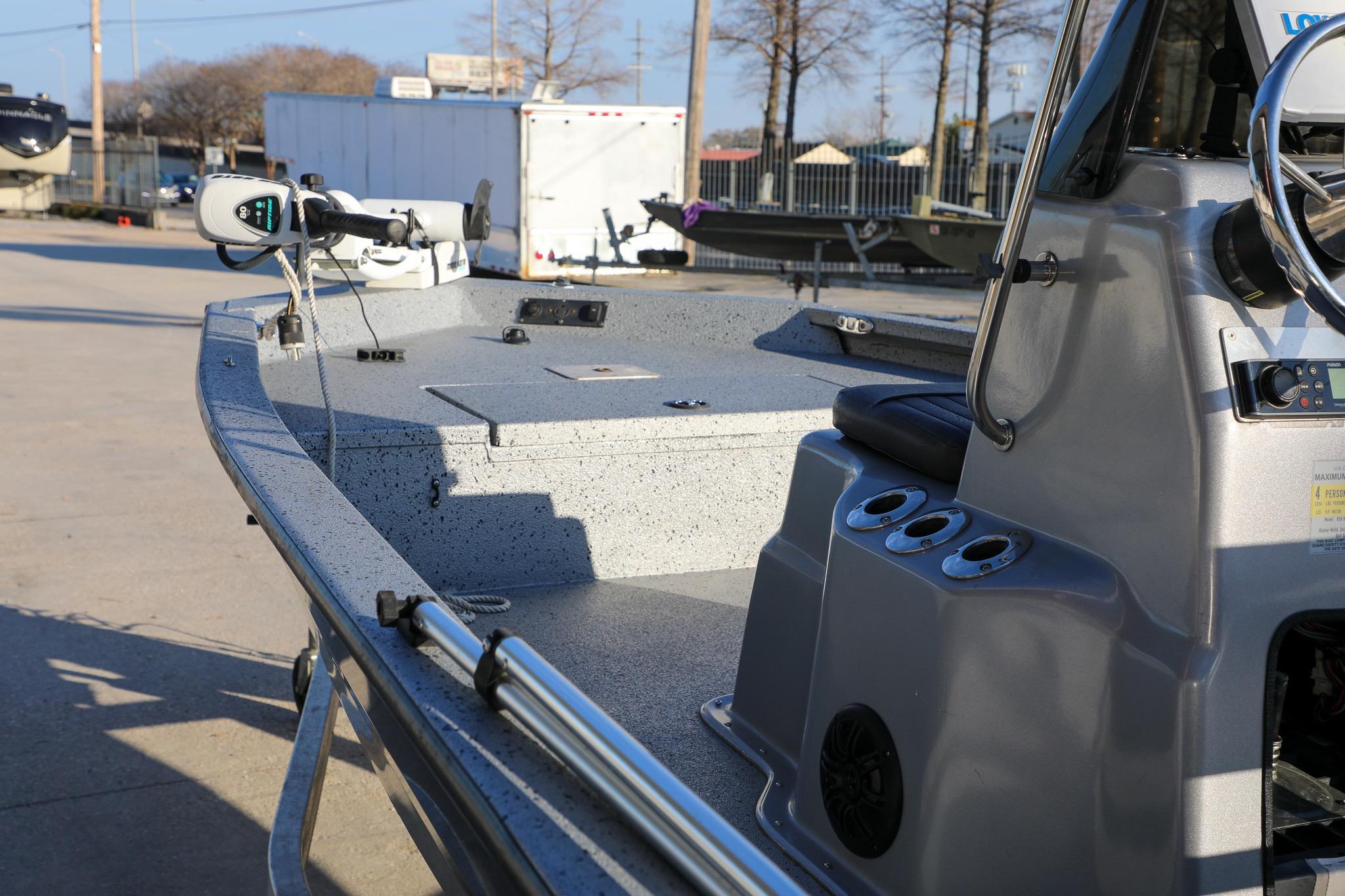 2019 Express 18 boat with steering console and trolling motor, parked outdoors.