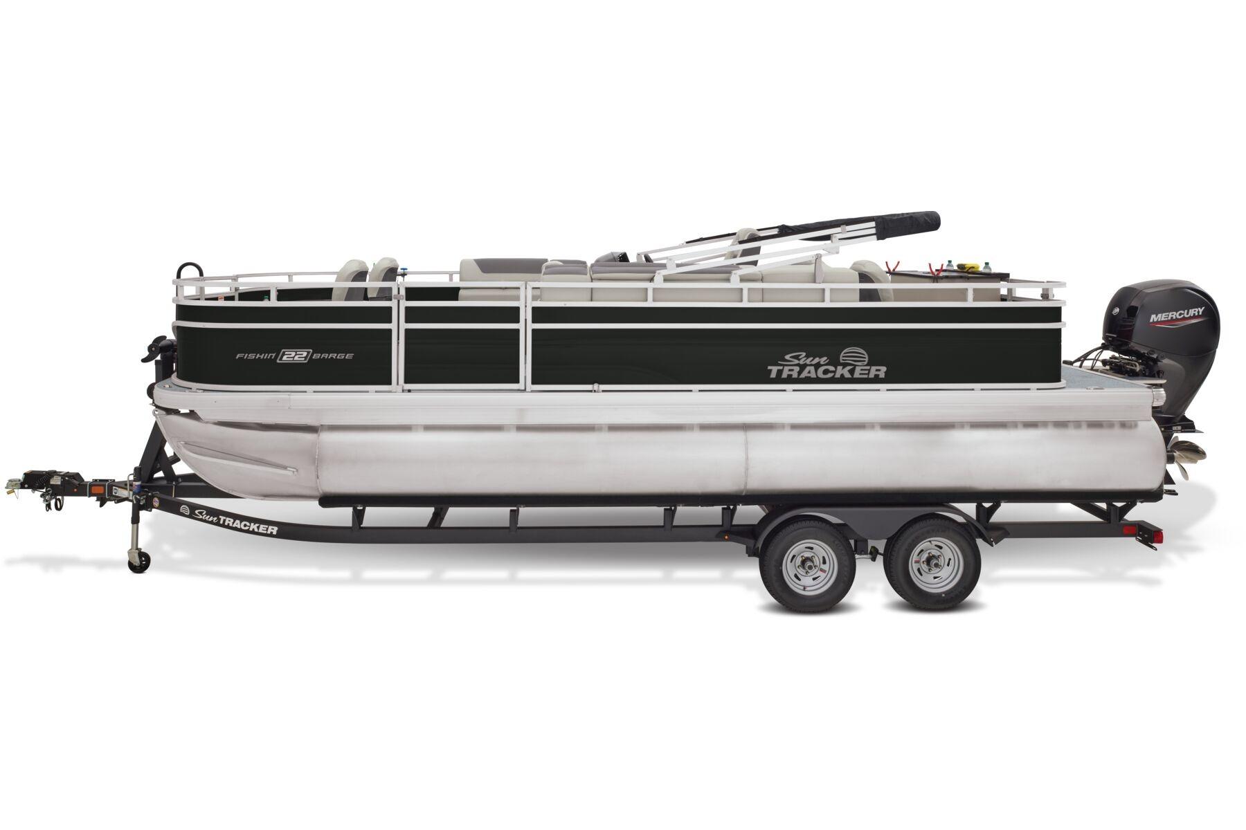 2026 Sun Tracker Fishin' Barge 22 DLX pontoon boat on trailer, side view.