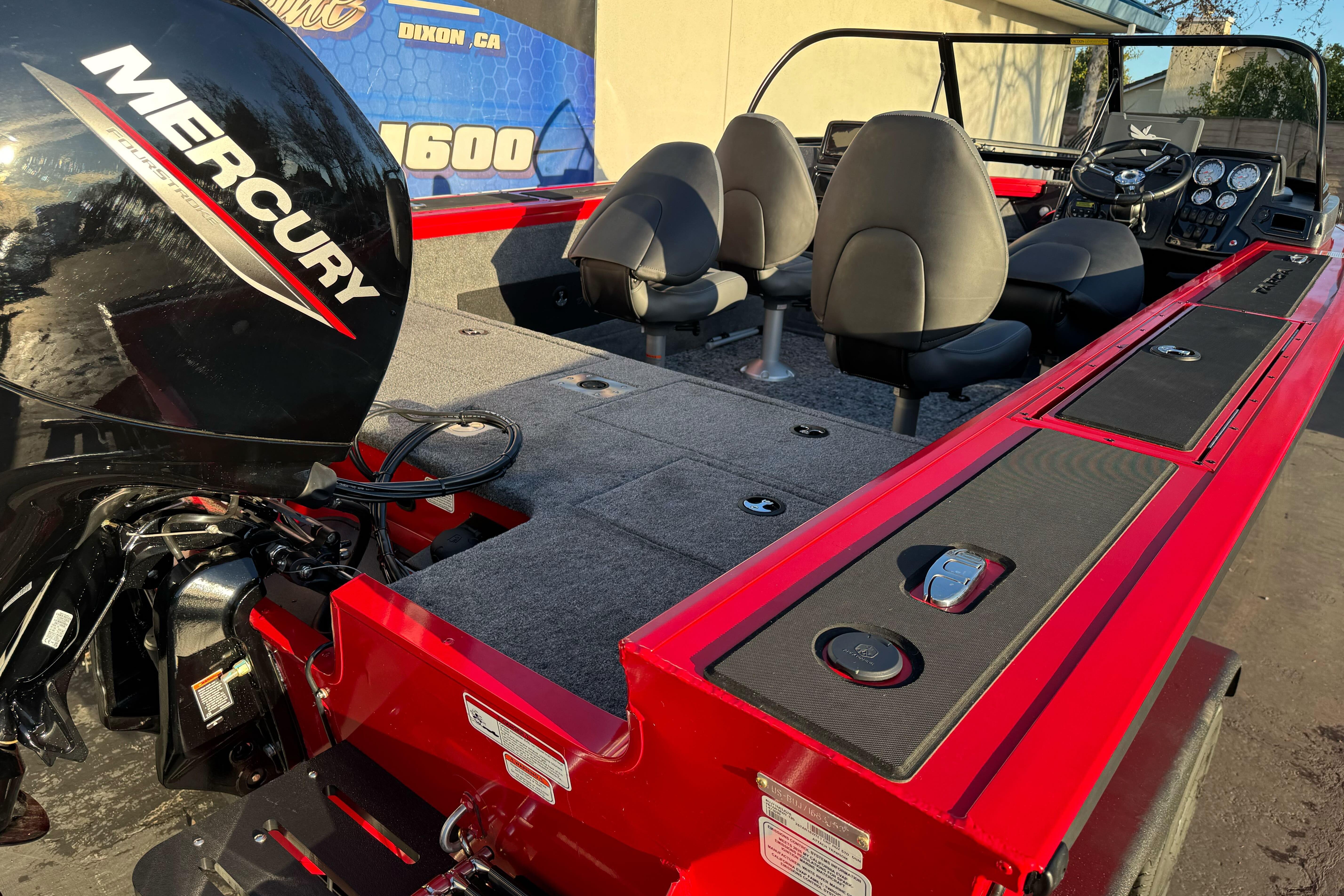 2026 Tracker Targa V-18 WT boat with Mercury engine, red interior, and seating.