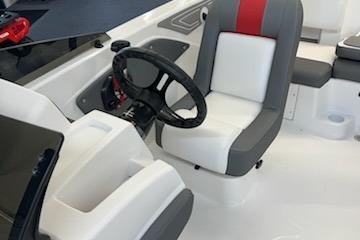 2025 Tahoe T21 boat interior with steering wheel and cushioned seating.