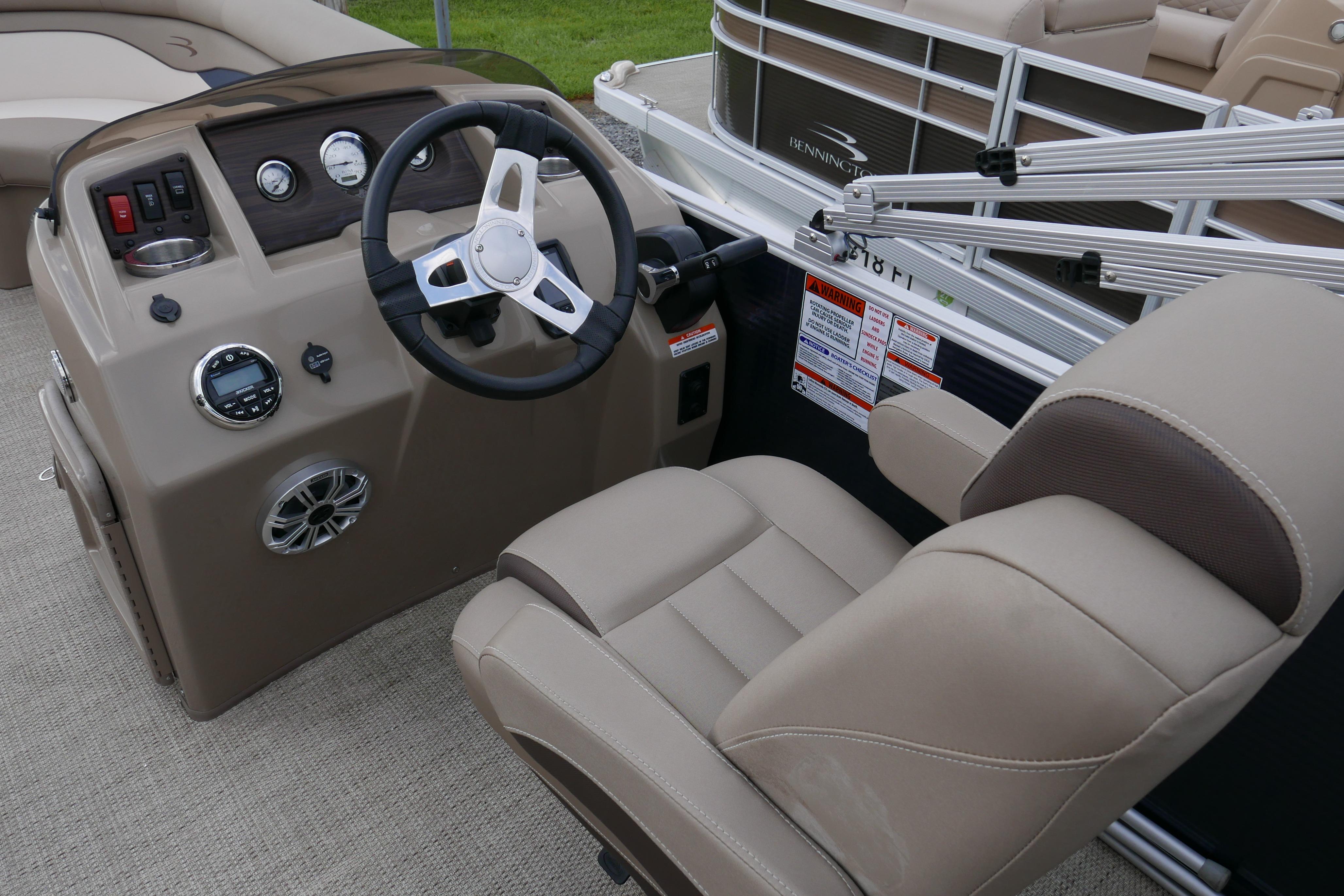 2019 Bennington SX 20 SLXP boat helm with beige seating and control panel.
