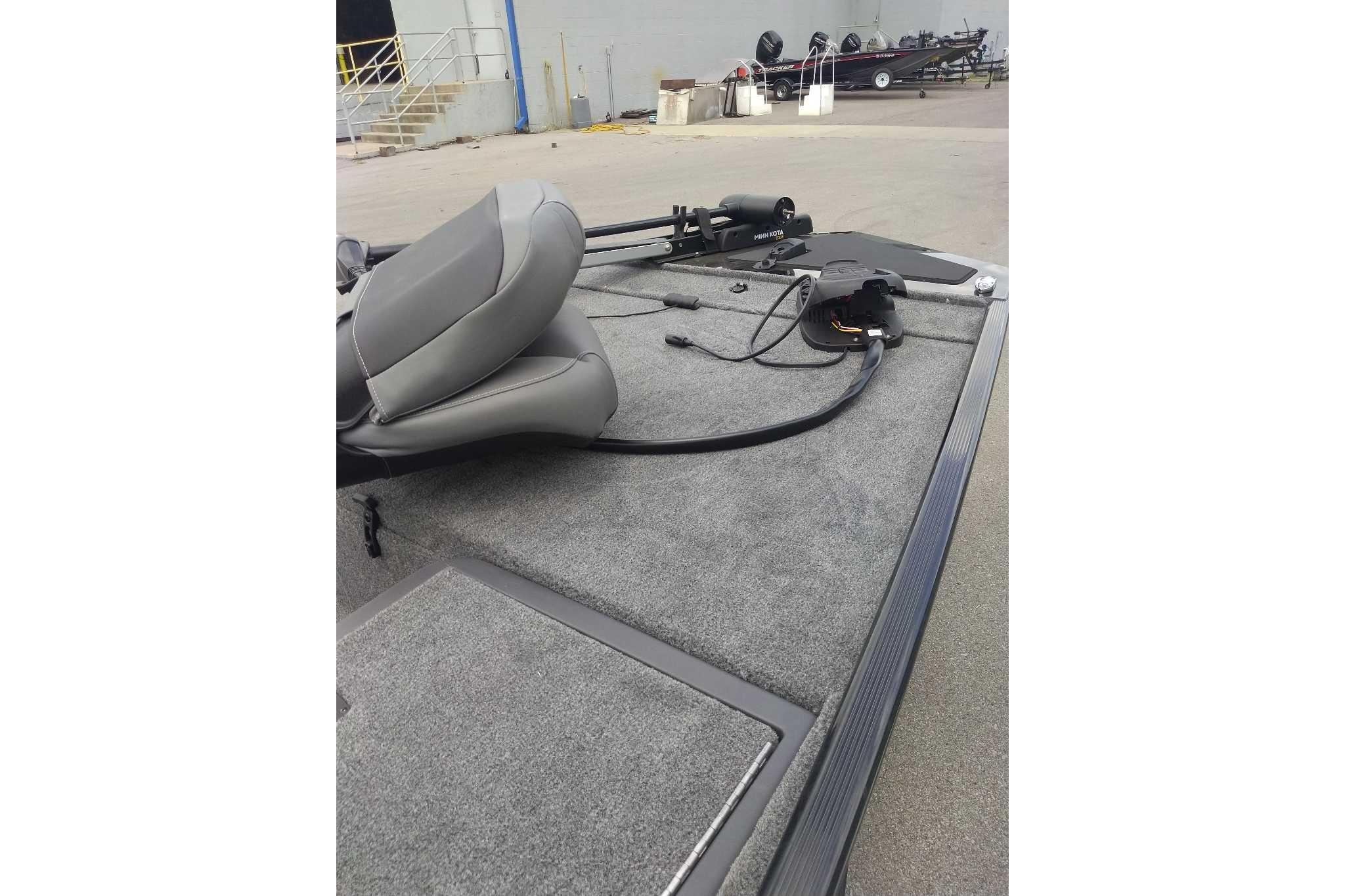 2026 Tracker Bass Tracker Classic XL boat interior with gray seating and carpeted deck.