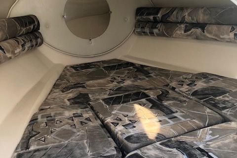 Interior of a 1999 Rinker 212 Fiesta Vee boat with patterned upholstery.