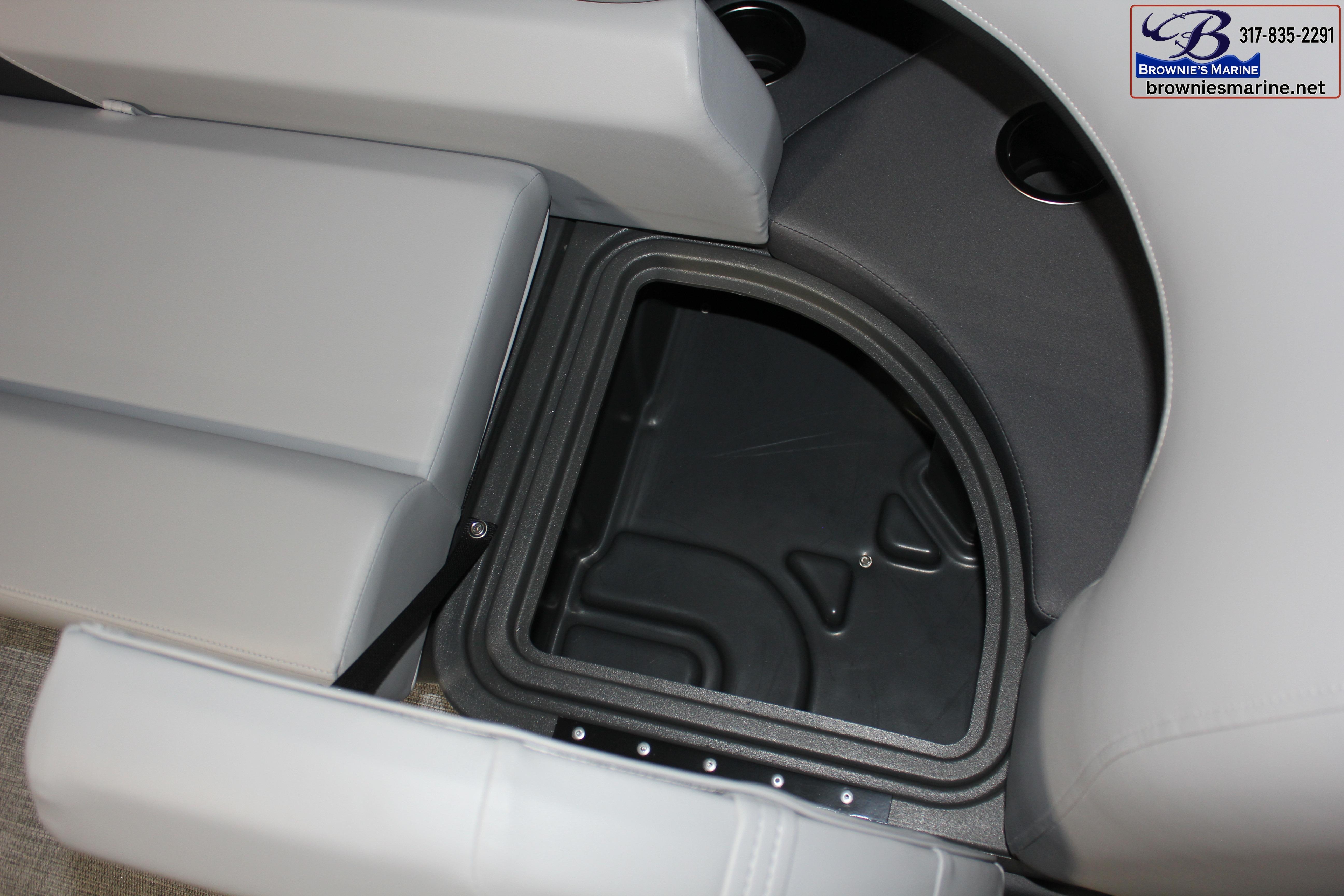 Sun Tracker Party Barge 22 DLX 2026 storage compartment with cushioned seating and cup holders.