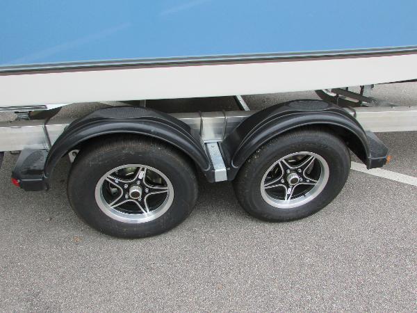 2023 Mako 214 CC boat trailer with dual axle wheels.