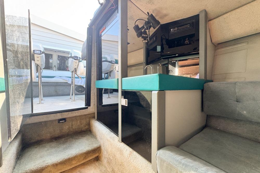 Interior of a 1989 Formula 292 SR-1 boat with seating and kitchenette.