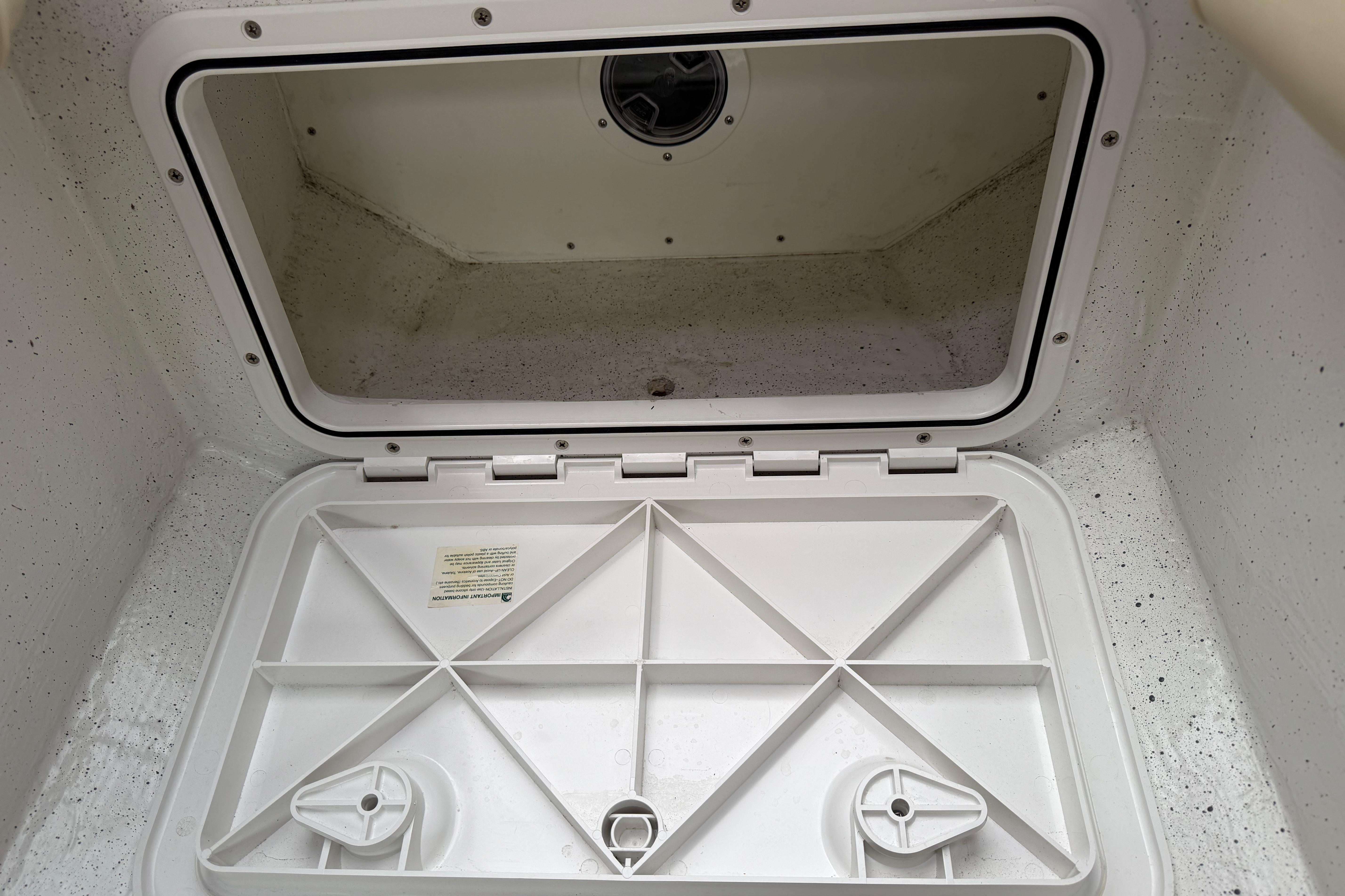 Open storage compartment on a 2016 Protector Targa 30 boat, showcasing interior space.