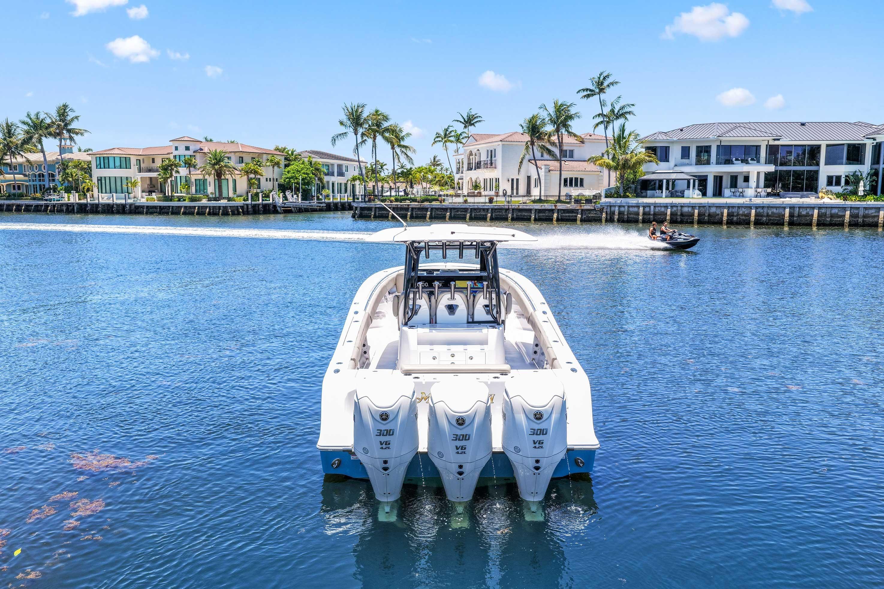 2024 Sportsman Open 352 Center Console boat on a sunny waterfront.