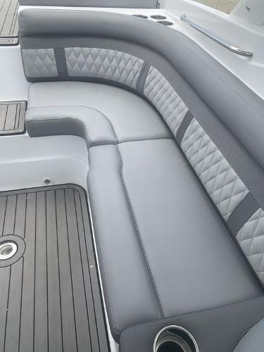 2020 Rinker 29QX BR boat with gray cushioned seating and diamond stitching.