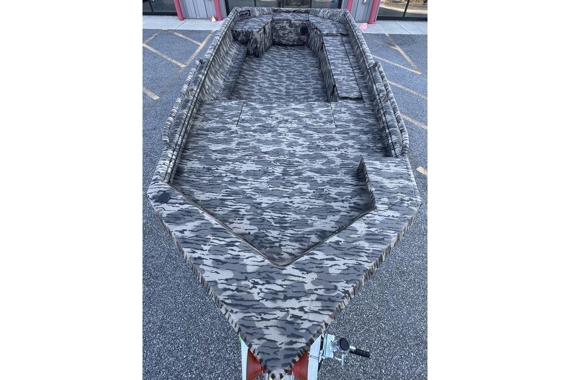 Camouflage-patterned interior of a 2026 Havoc 1756 boat, parked on asphalt.