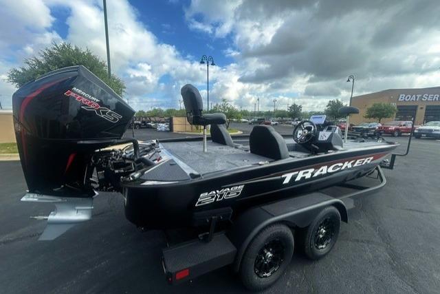 2026 Tracker Savage 215 boat with powerful engine, parked outdoors under cloudy sky.