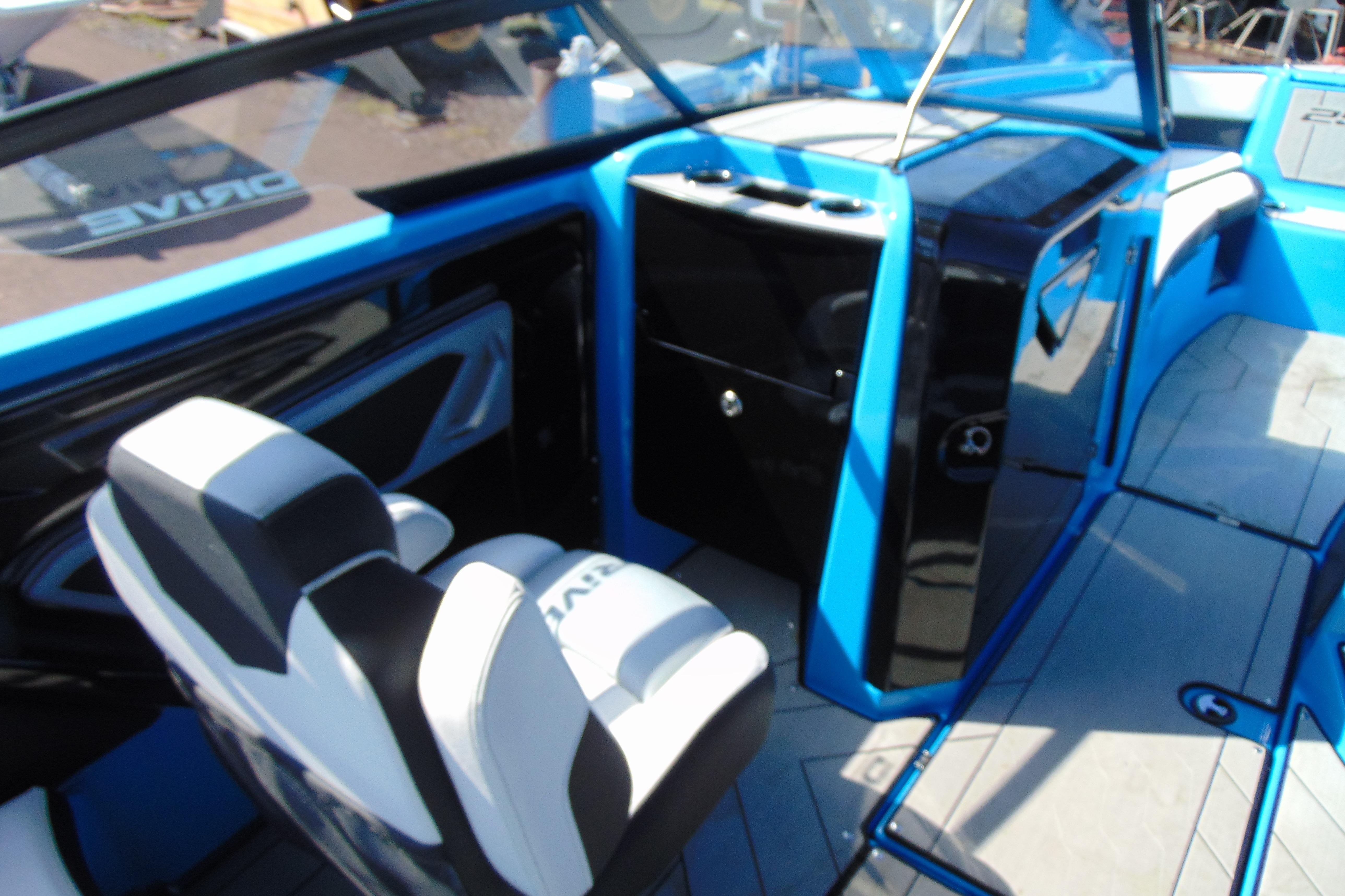 Interior of 2022 Yamaha Boats 255XD, featuring sleek blue and black design with comfortable seating.