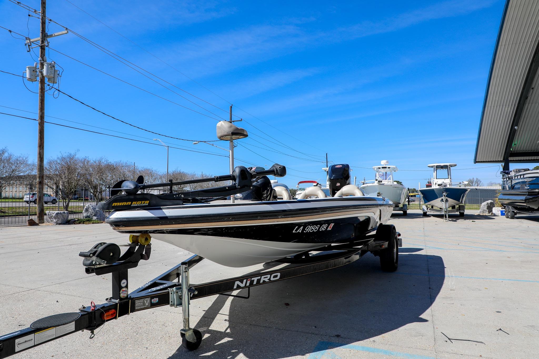 2013 Nitro Z-7 boat on trailer under clear blue sky at marina.