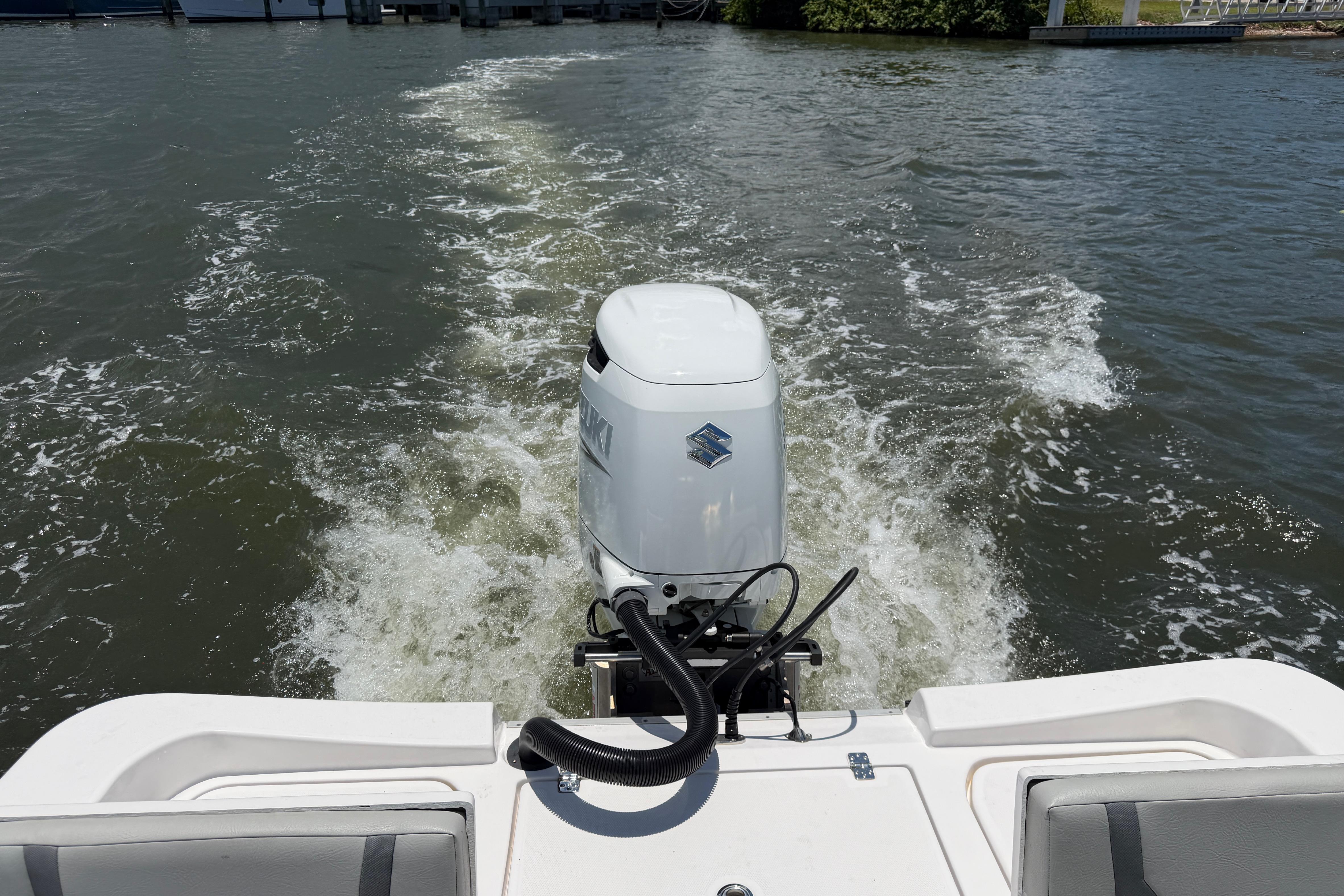 2022 Aquasport 230 Pro Bay boat with powerful outboard motor on water.