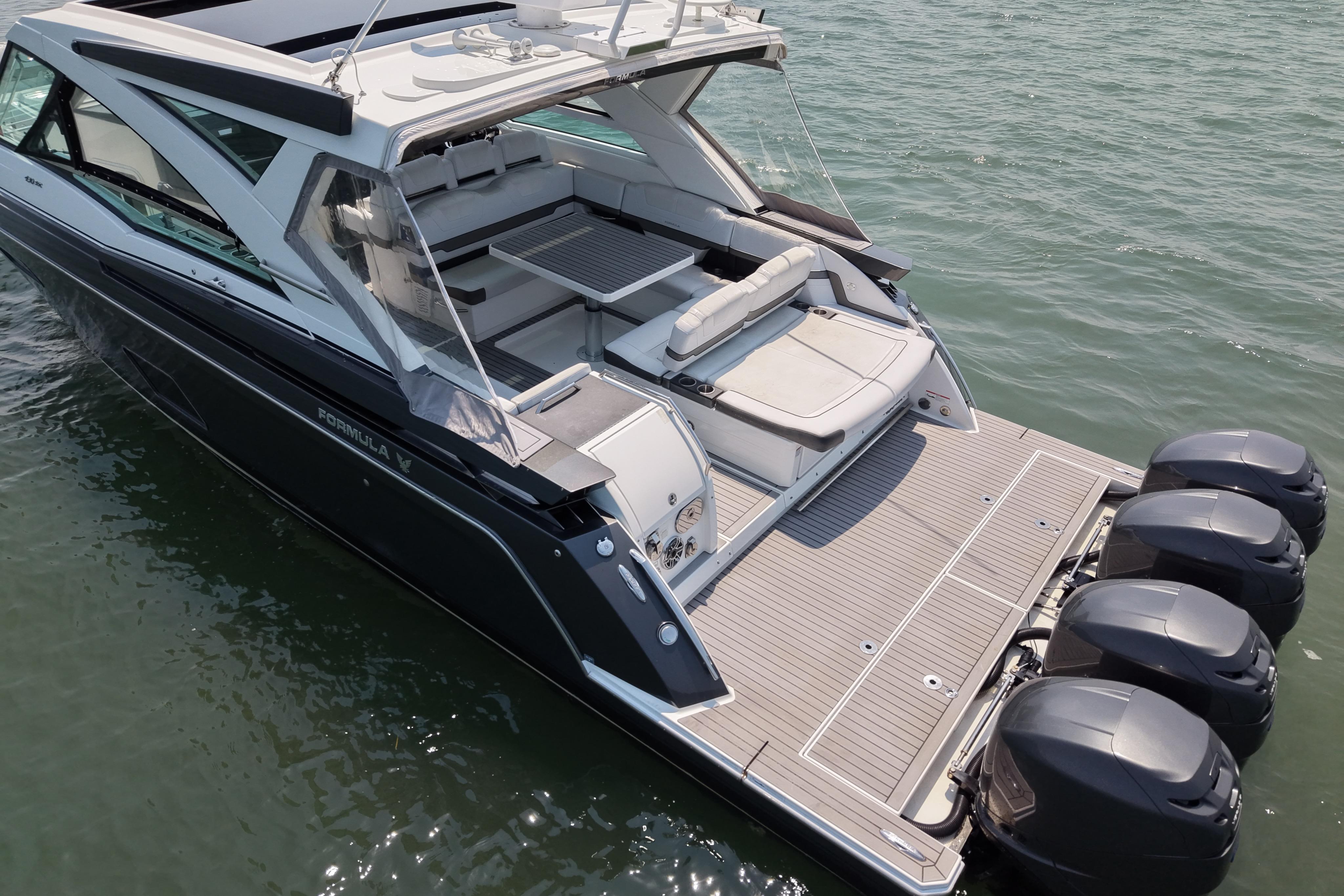 2019 Formula 430 Super Sport Crossover boat on water, featuring spacious deck and multiple engines.