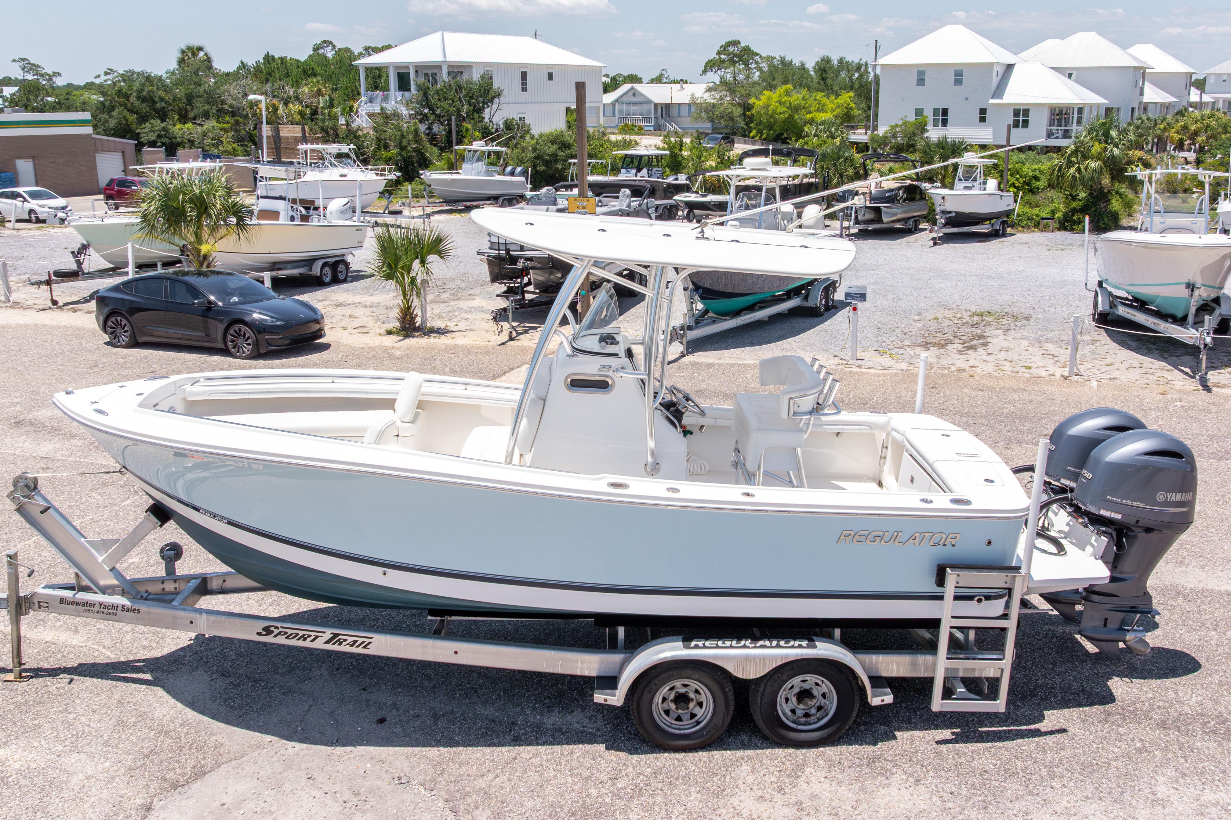 2019 Regulator 23 Center Console boat on trailer, parked outdoors in a marina setting.