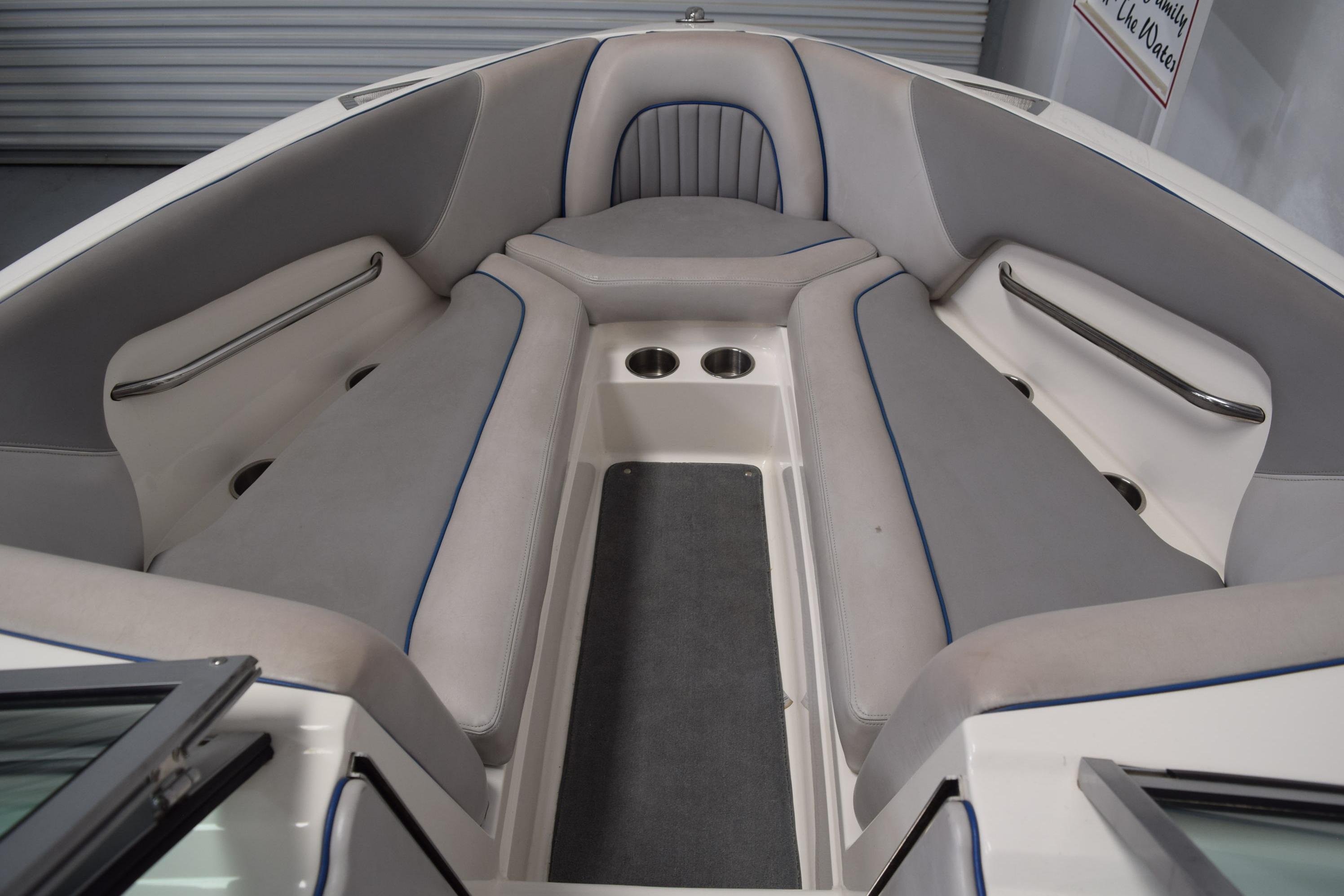 Interior of a 2007 Centurion SV 240 boat with cushioned seating and cup holders.