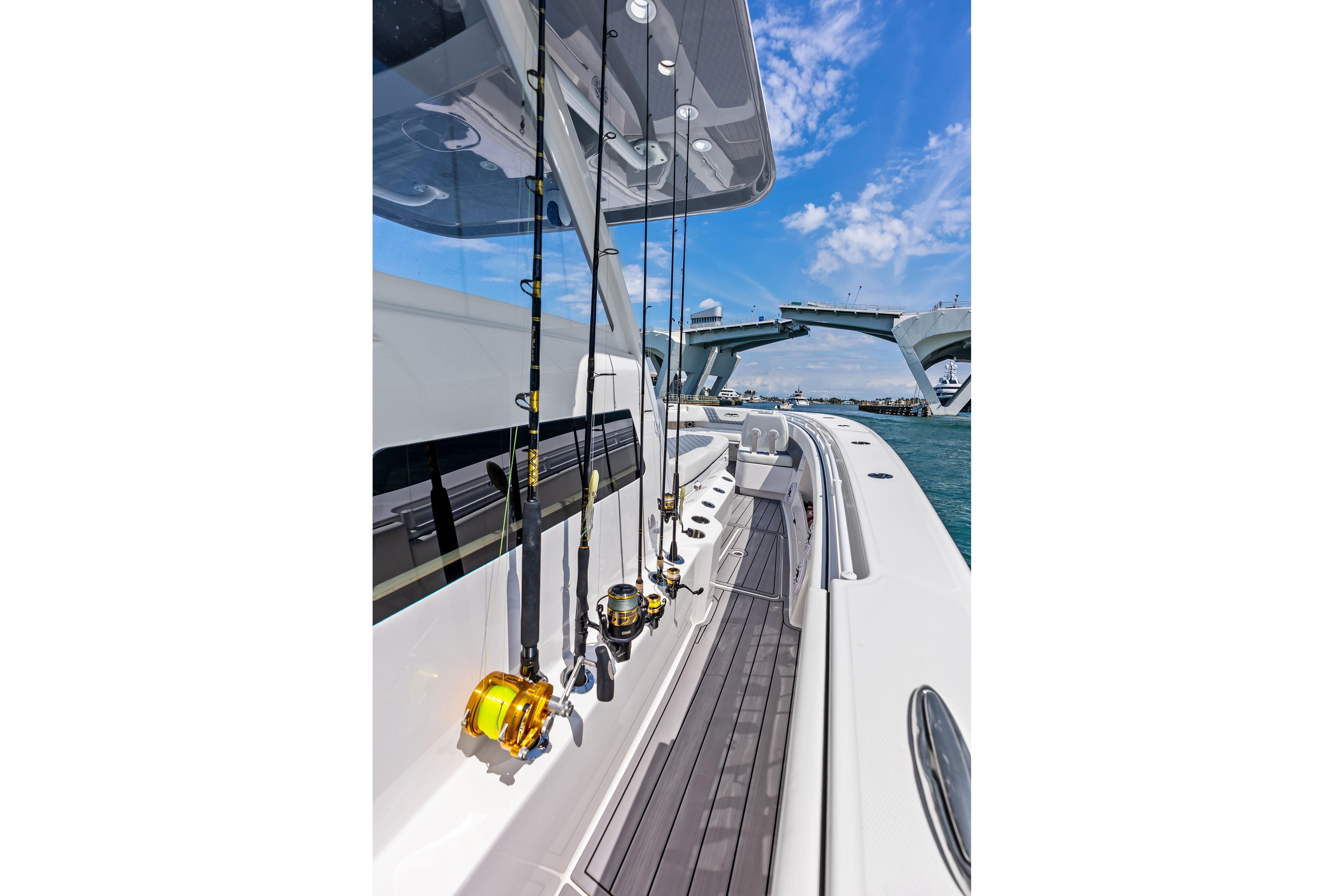 2024 Invincible 43 Open Fisherman with fishing rods, under a clear blue sky.