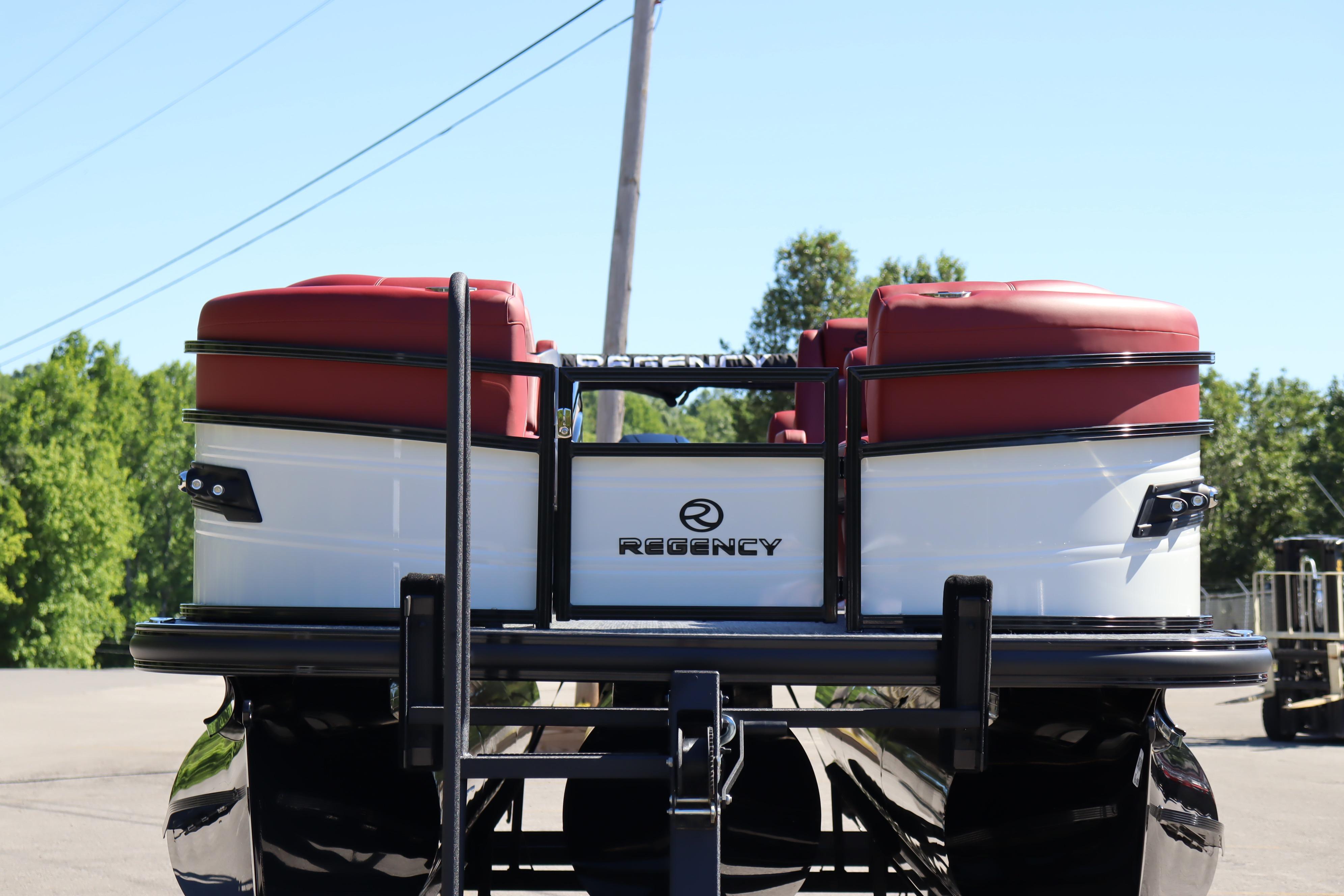 2026 Regency 250 DL pontoon boat with red seating, viewed from the rear.