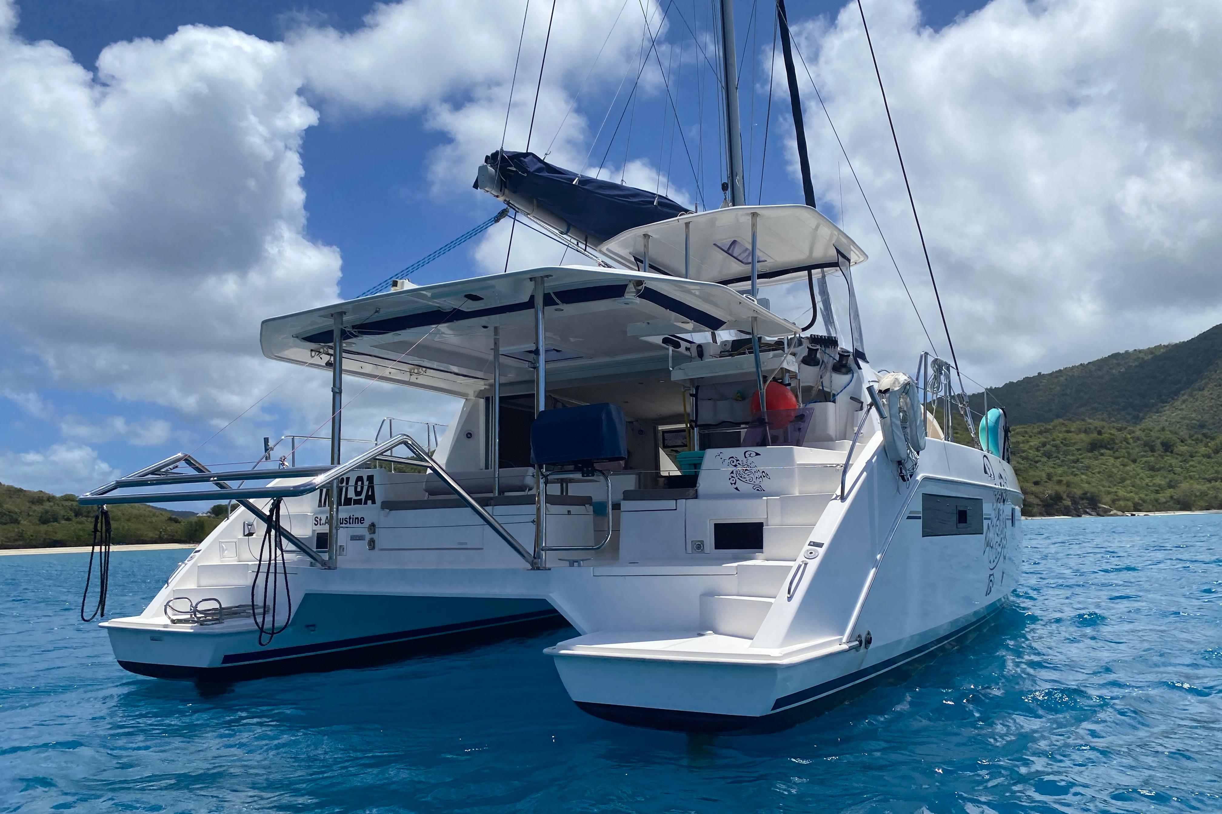 2017 Leopard 40 catamaran anchored in clear blue water, scenic island backdrop.