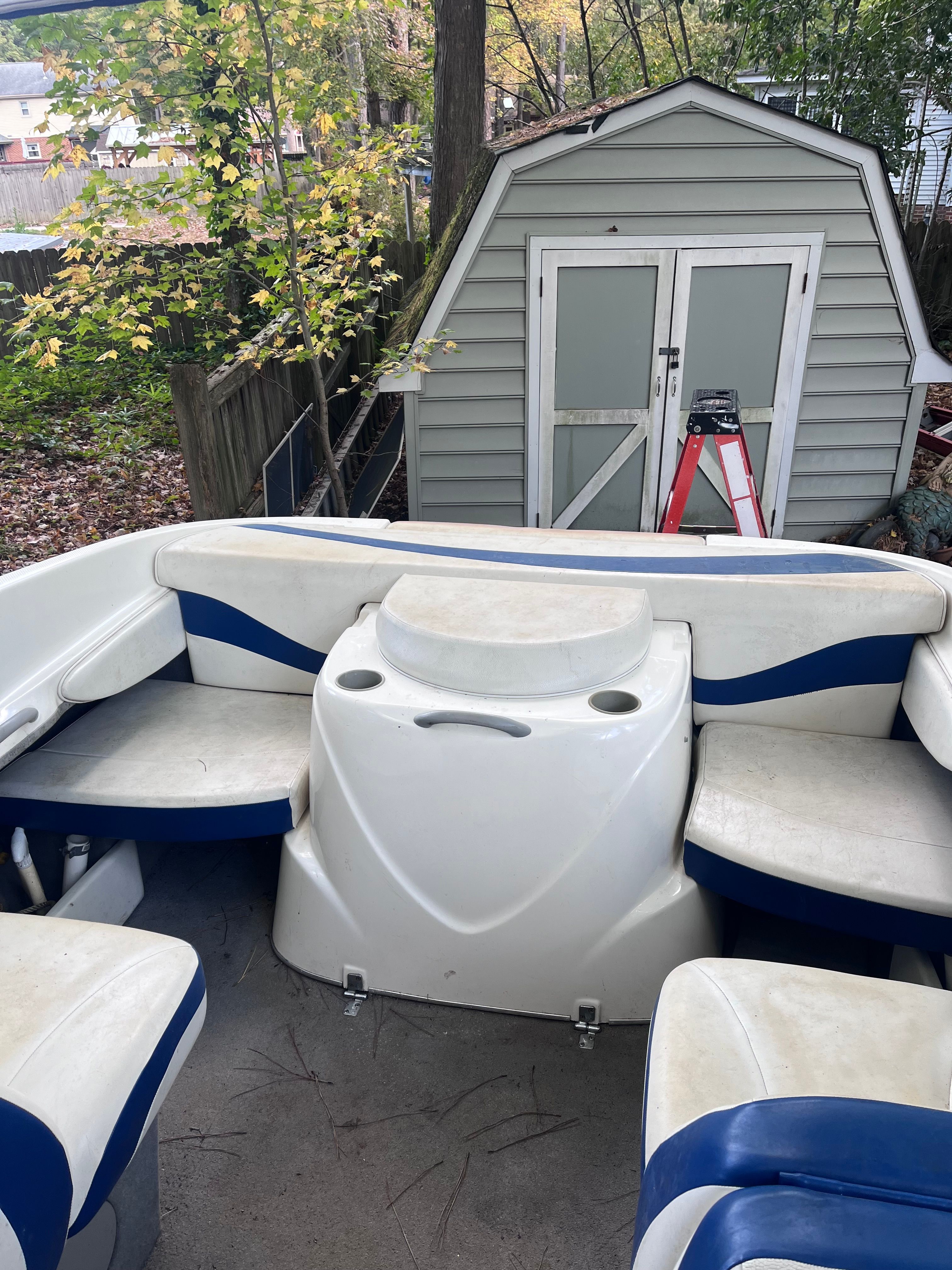 Interior of a 2005 Bayliner Cuddy Capri boat with seating area.