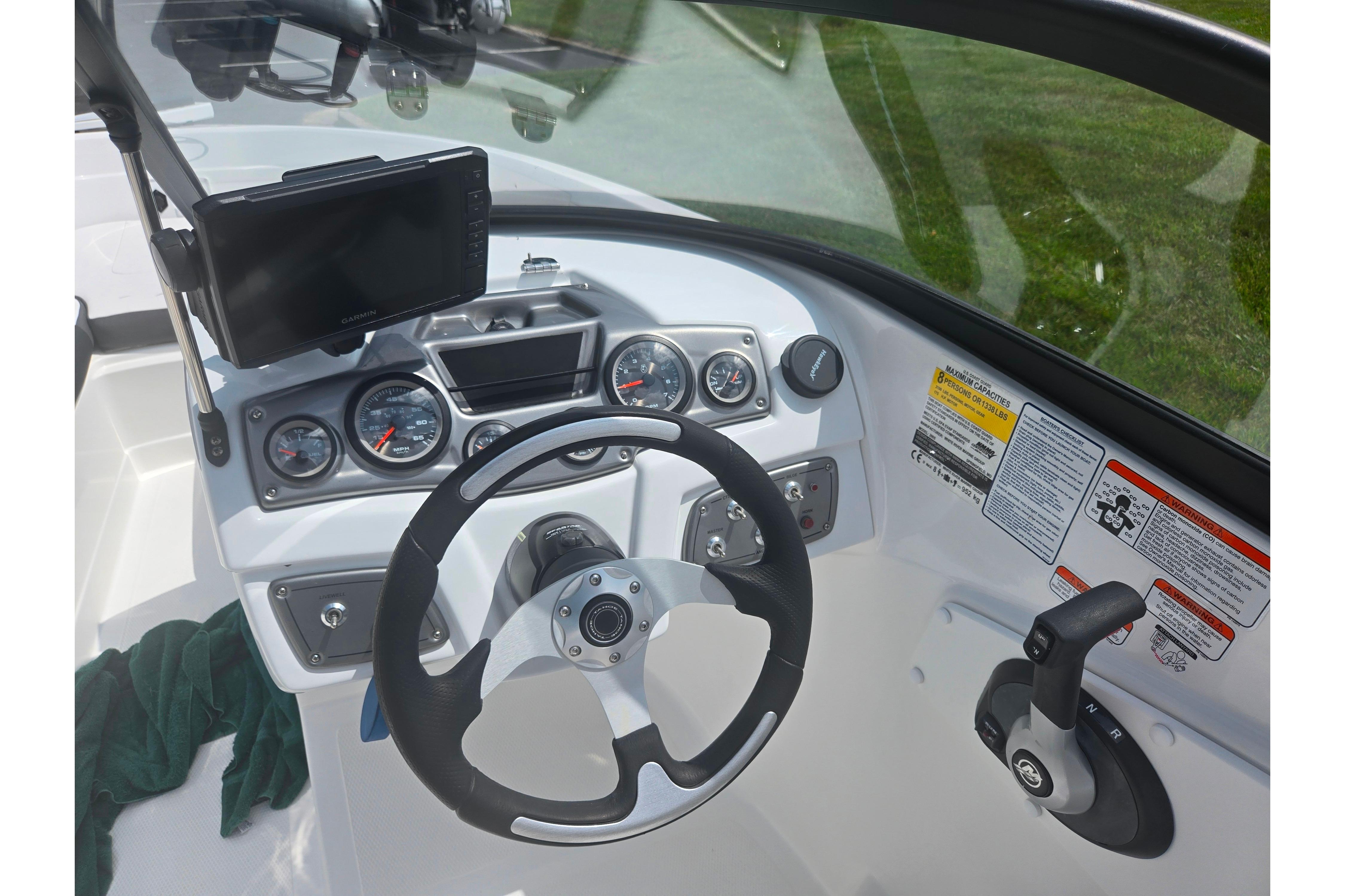 2023 Tahoe 200 S boat dashboard with steering wheel, gauges, and control panel.