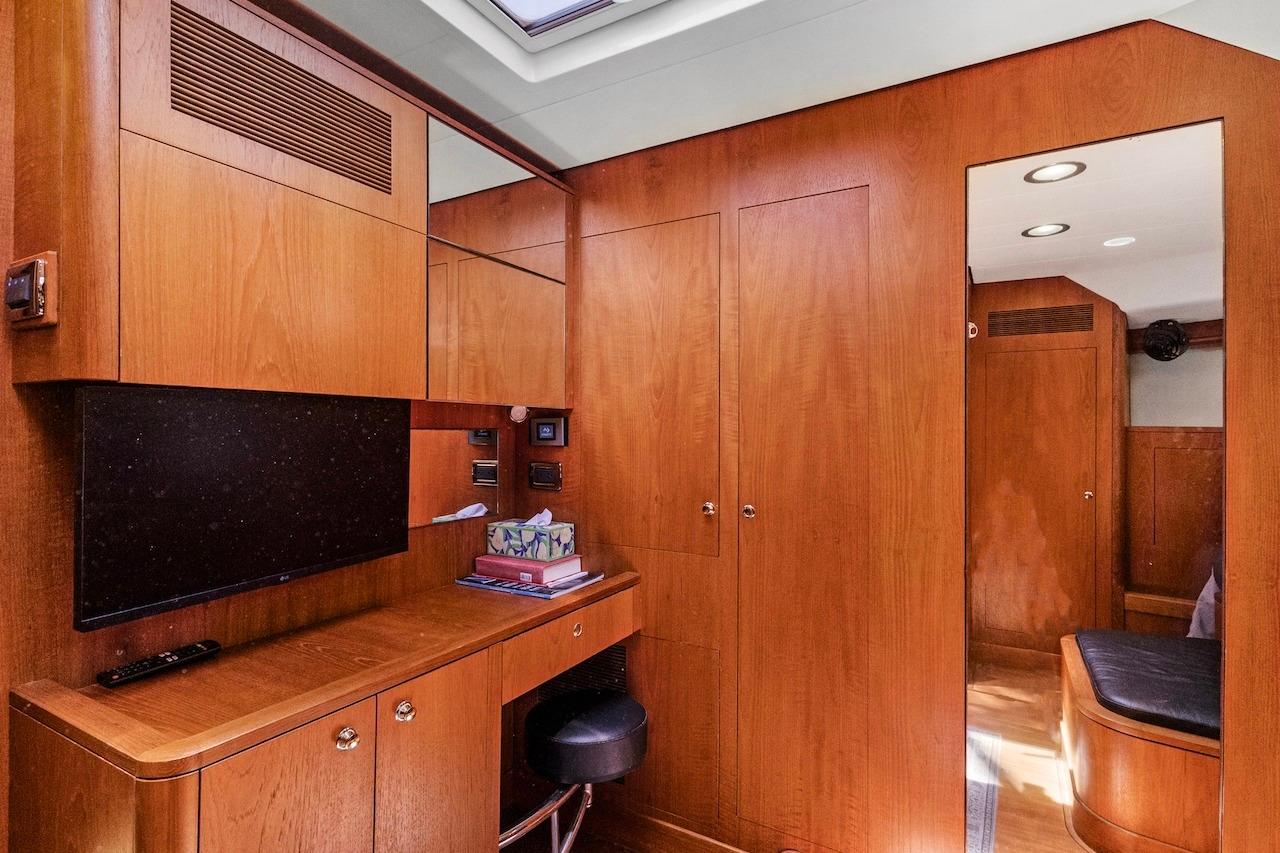 Luxurious wooden interior of 2011 Southerly 57 RS yacht with desk and mirror.