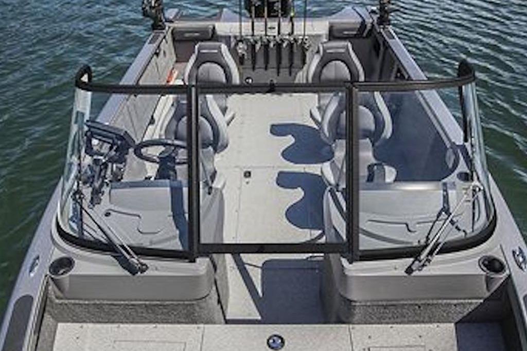 2026 Crestliner 2050 Authority boat interior with seating and steering, on calm water.