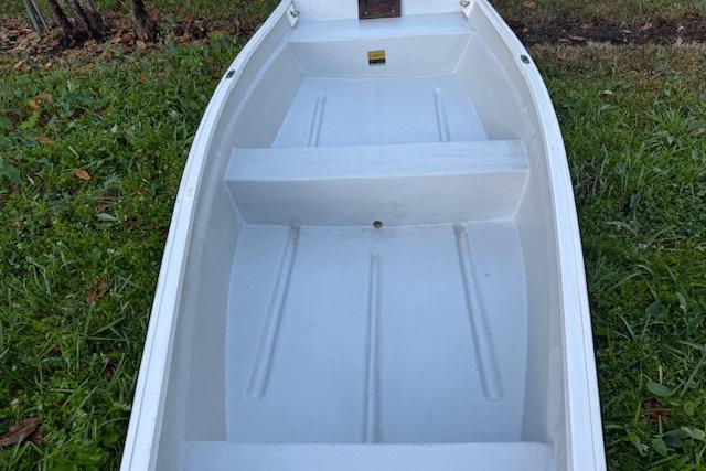 1999 Beacon Boats Pram on grass, showcasing interior seating and structure.