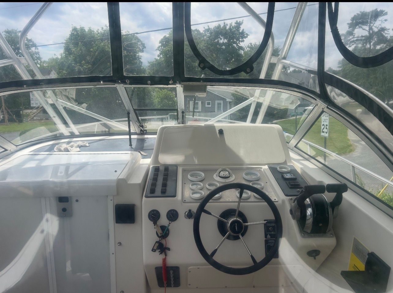 The cockpit of a Pro-Line 2950 Walkaround boat with steering and instruments.