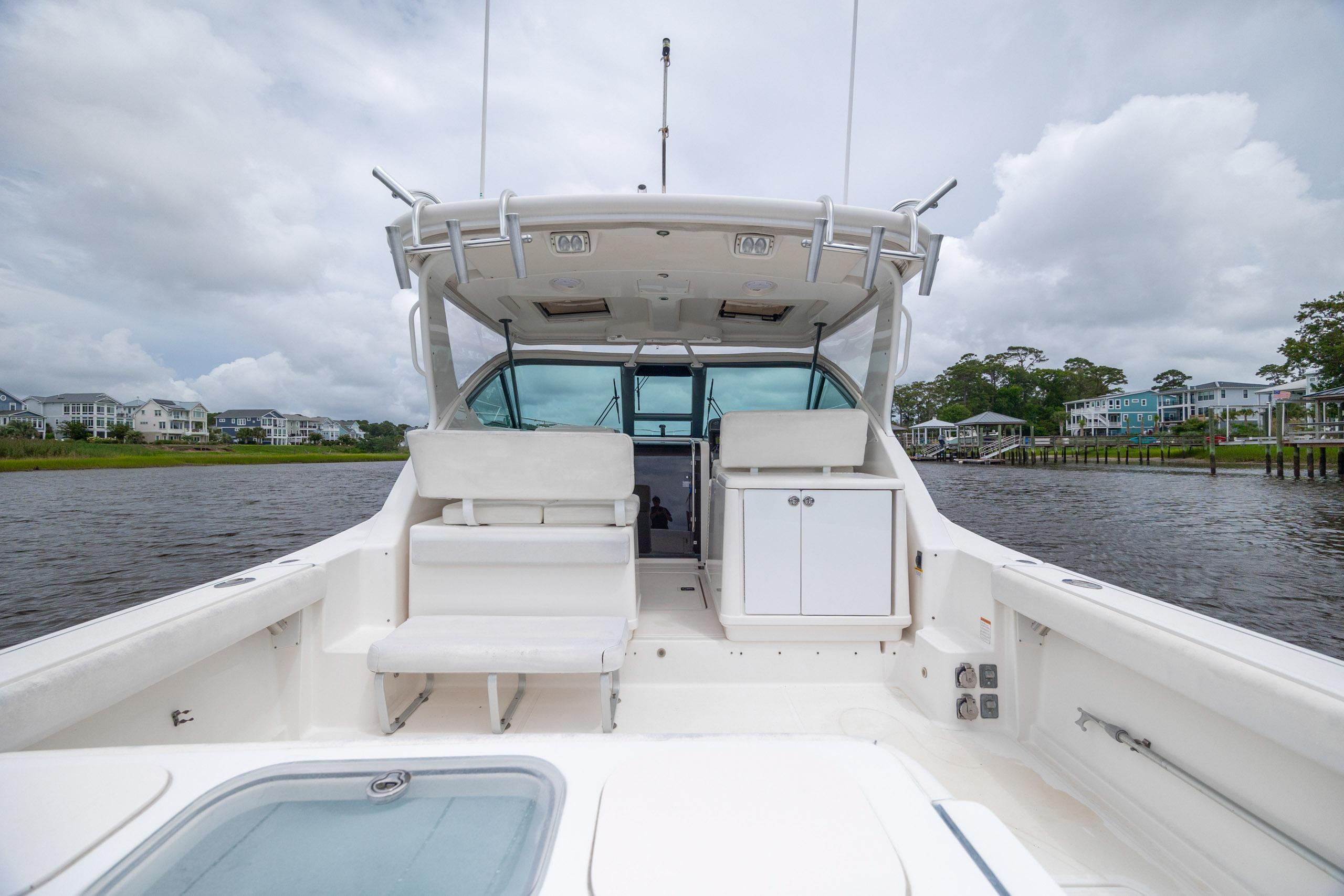 2004 Tiara Yachts 3200 Open boat interior with seating and storage, dockside view.