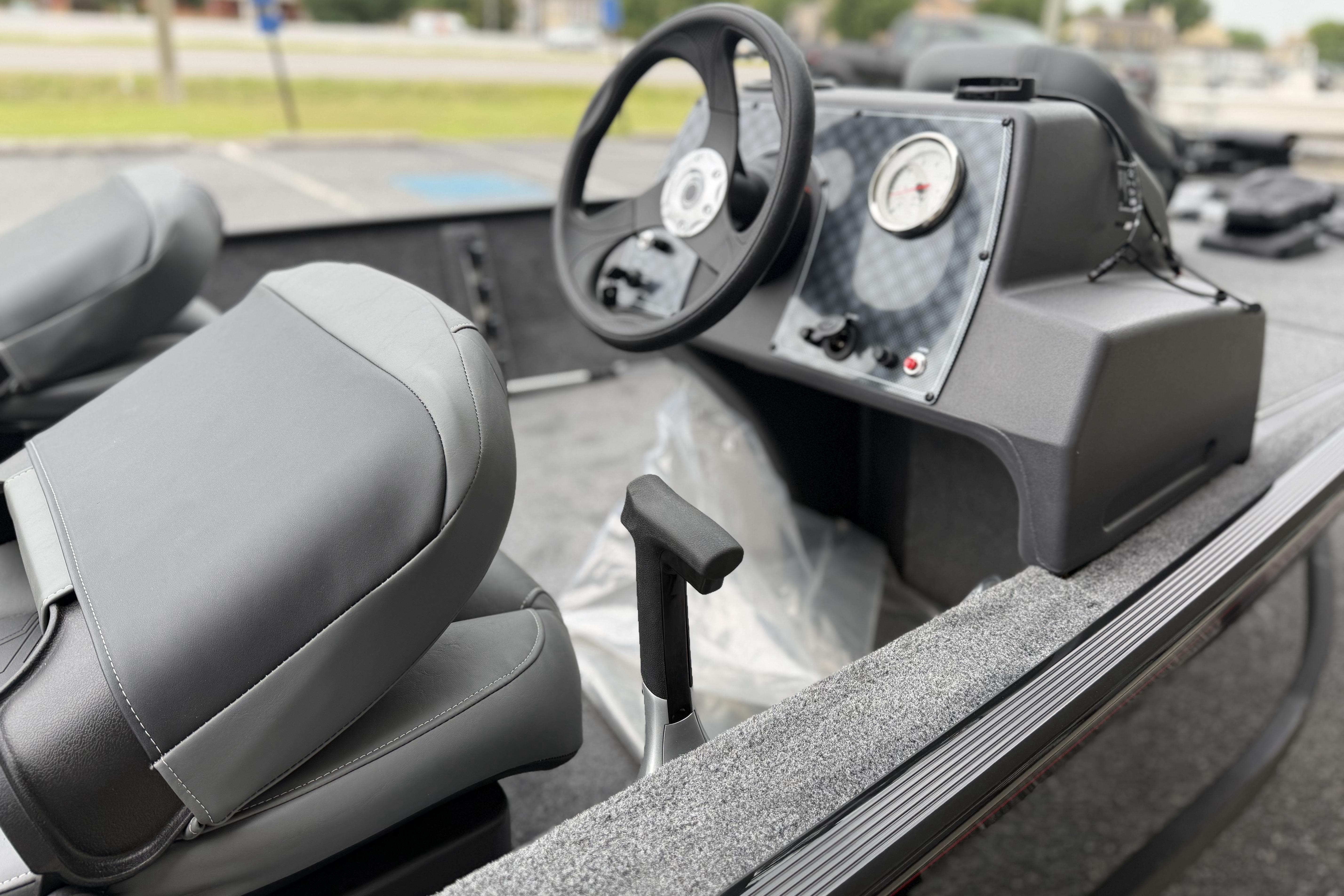 2026 Tracker Bass Tracker Classic XL boat interior with steering wheel and seats.
