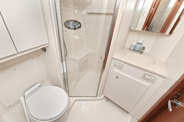 Bathroom interior of 2008 Tiara Yachts 4200 Open, featuring shower, toilet, and sink.