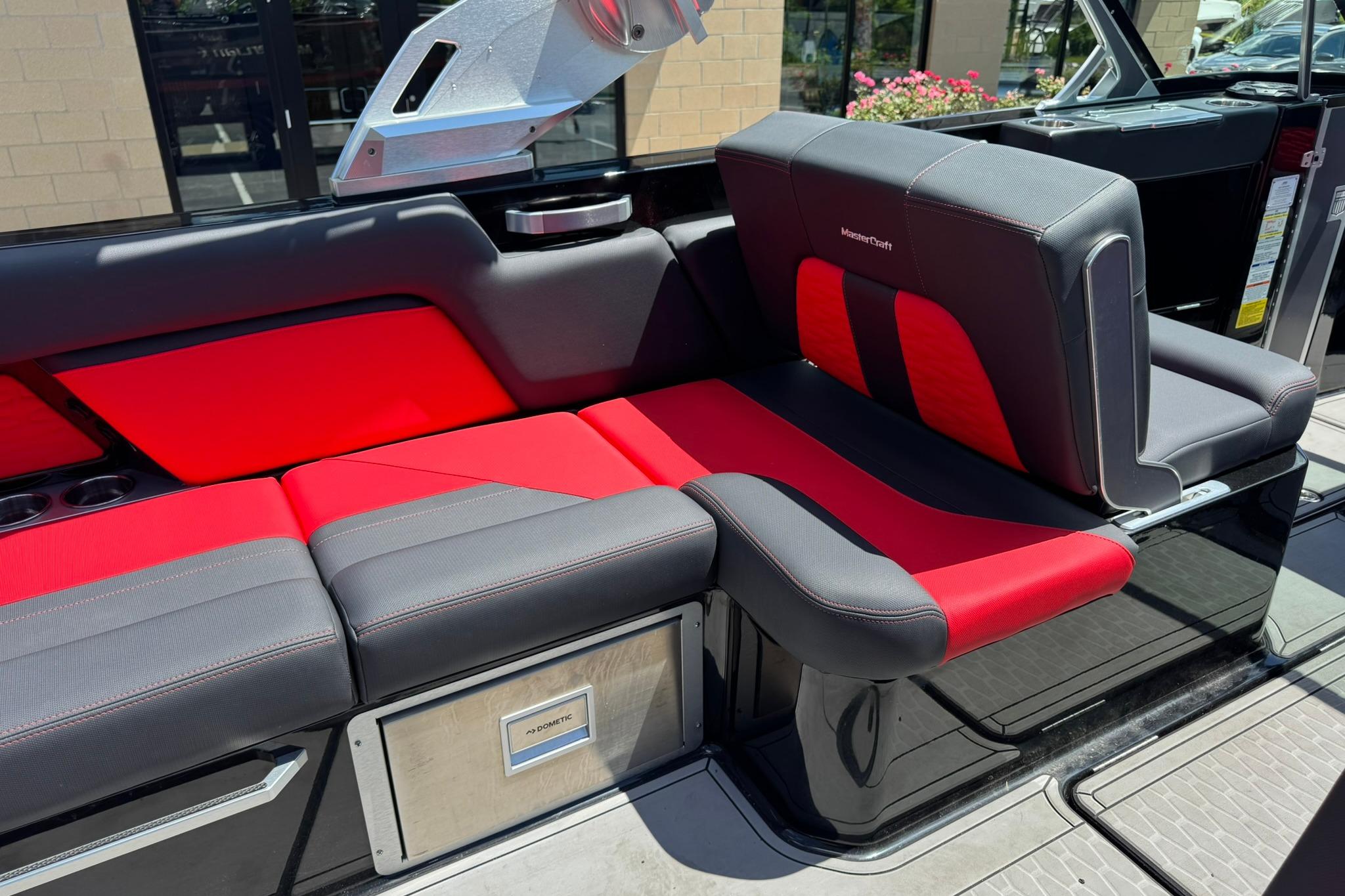 2021 MasterCraft X26 boat interior with red and gray seating.