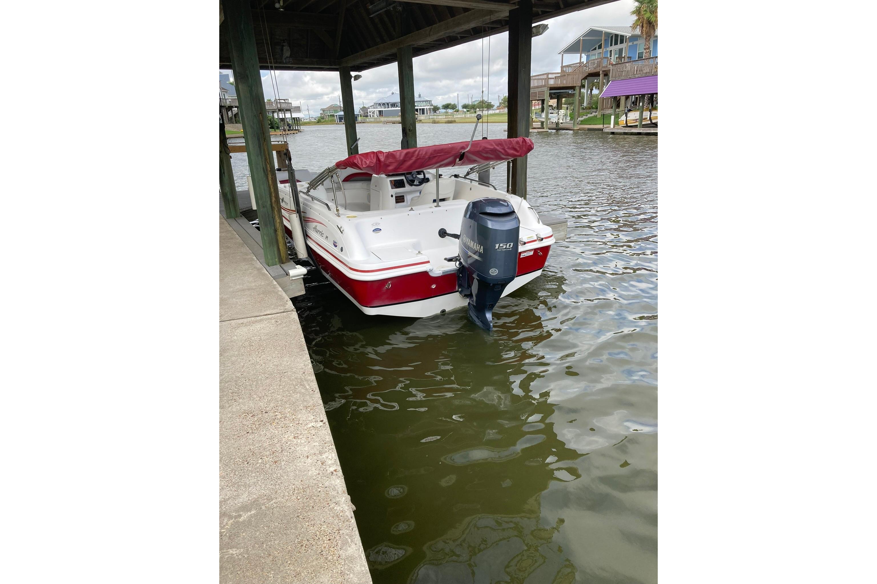 2013 Hurricane SunDeck Sport 201 OB boat docked with Yamaha 150 outboard motor.