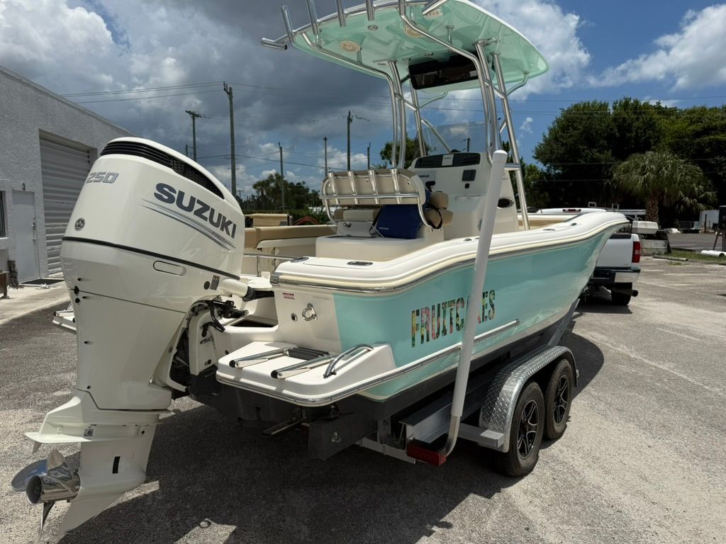 2021 Pioneer 22 SF boat with Suzuki engine on trailer.