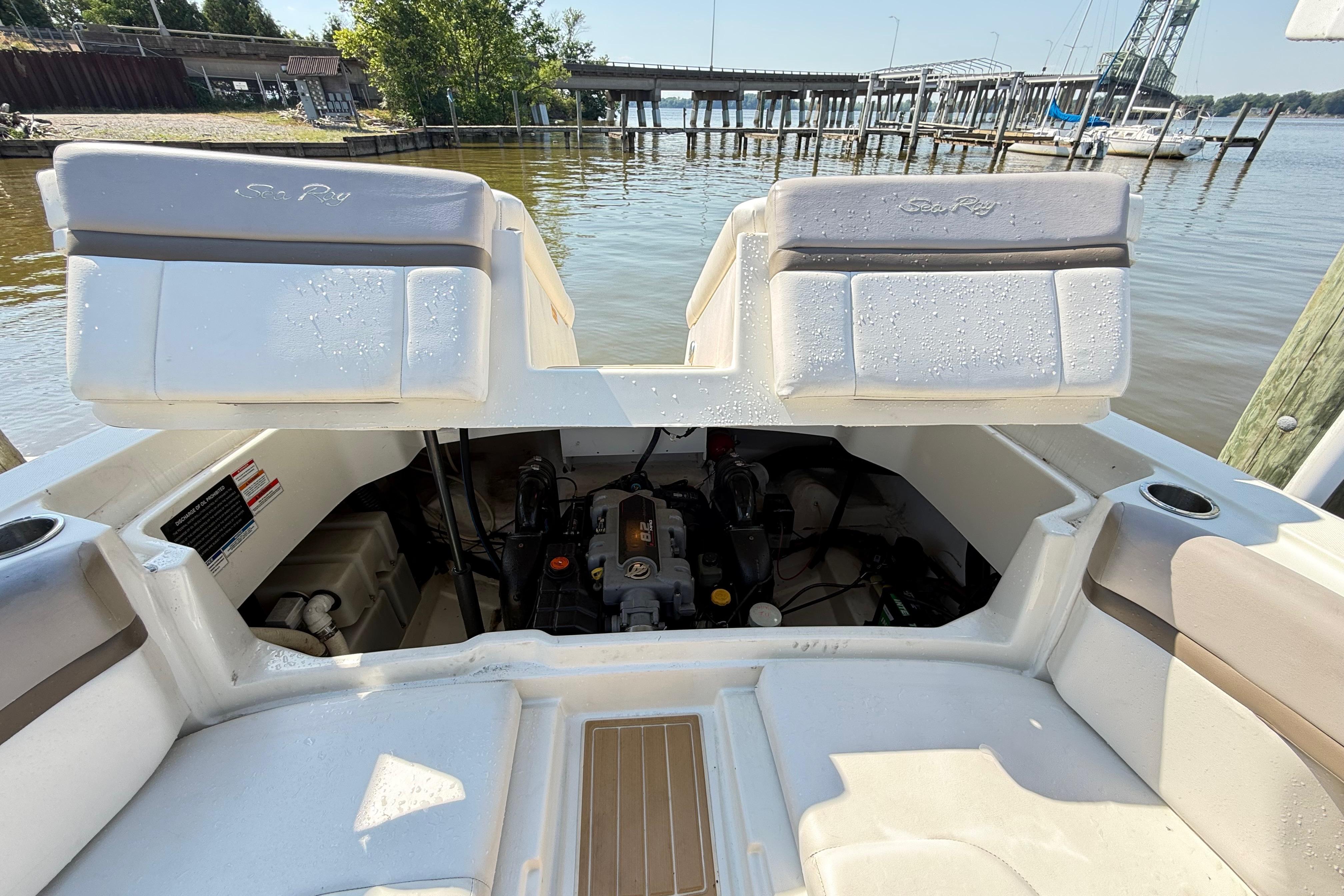 2011 Sea Ray 270 SLX boat engine compartment with open seating, dockside view.