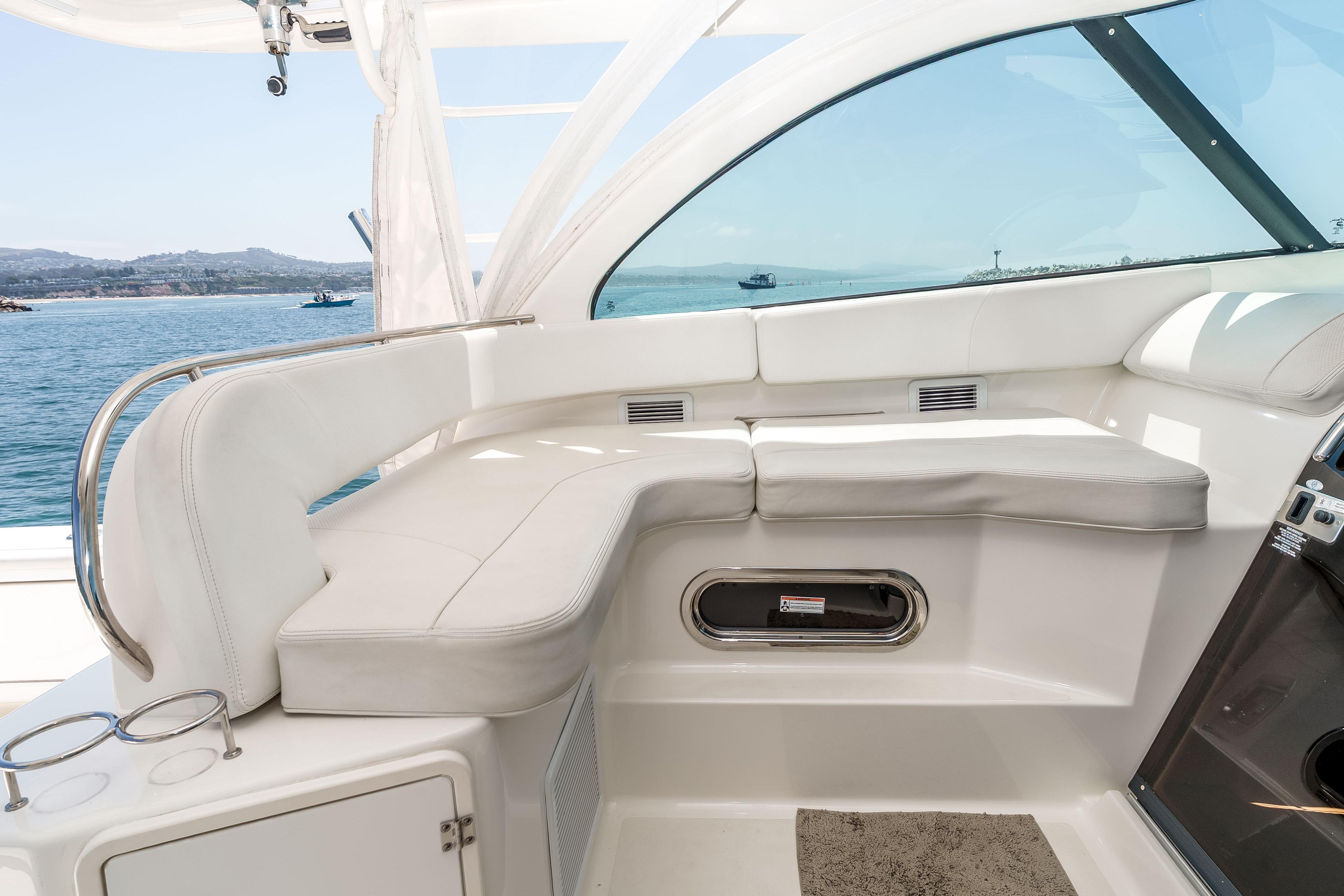 2022 Pursuit OS 385 Offshore boat interior with white seating and ocean view.