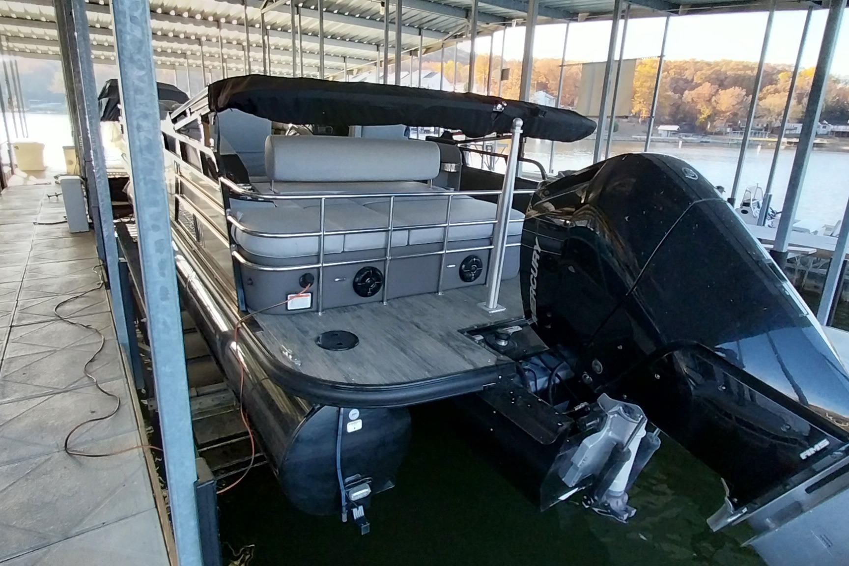 2023 Ranger 2500LS pontoon boat docked with powerful outboard motor.