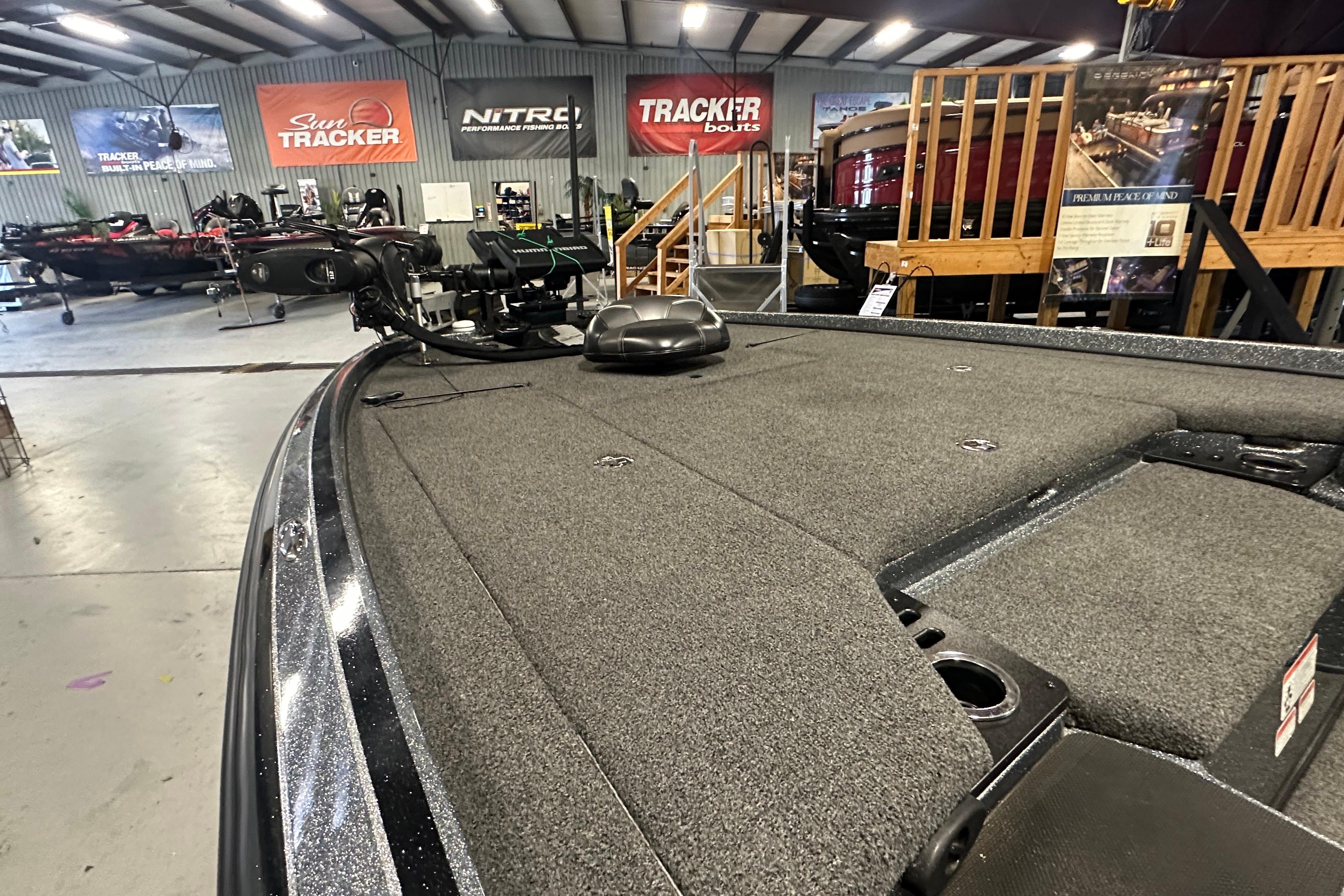2018 Nitro Z20 Pro fishing boat interior in showroom with various boat models displayed.