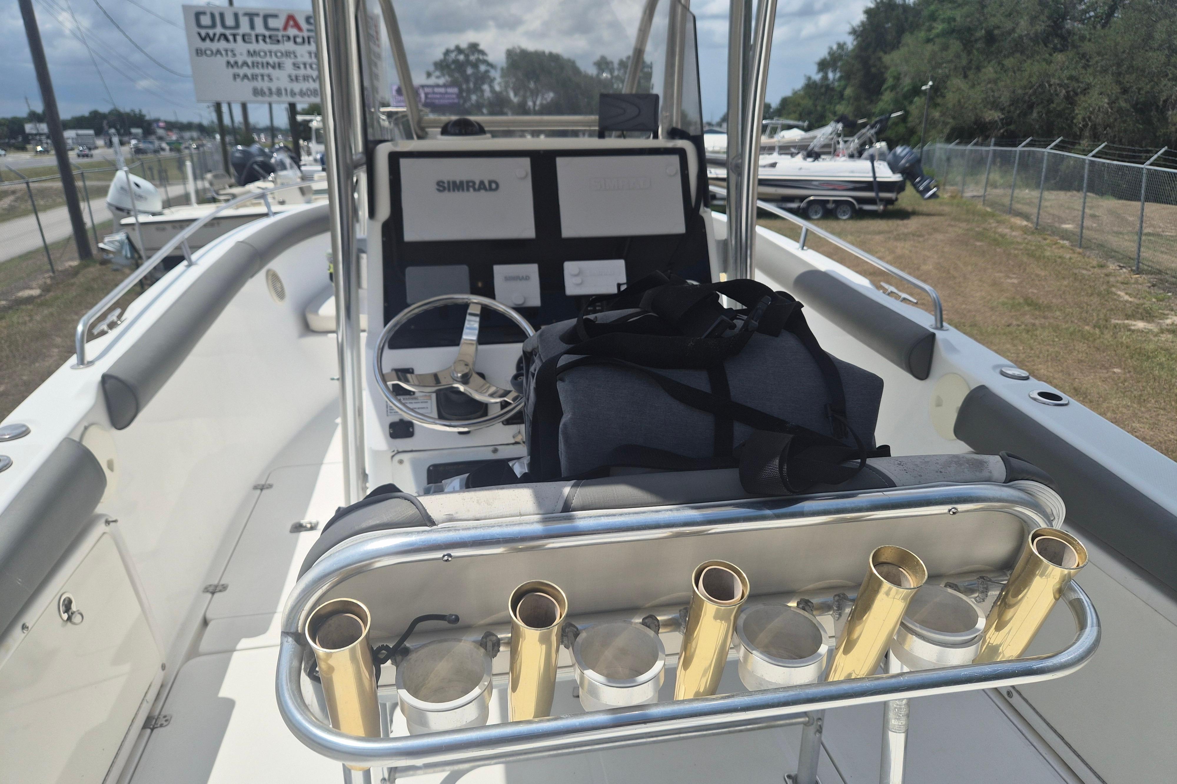 2006 Century 2900 Center Console boat interior with steering wheel and rod holders.