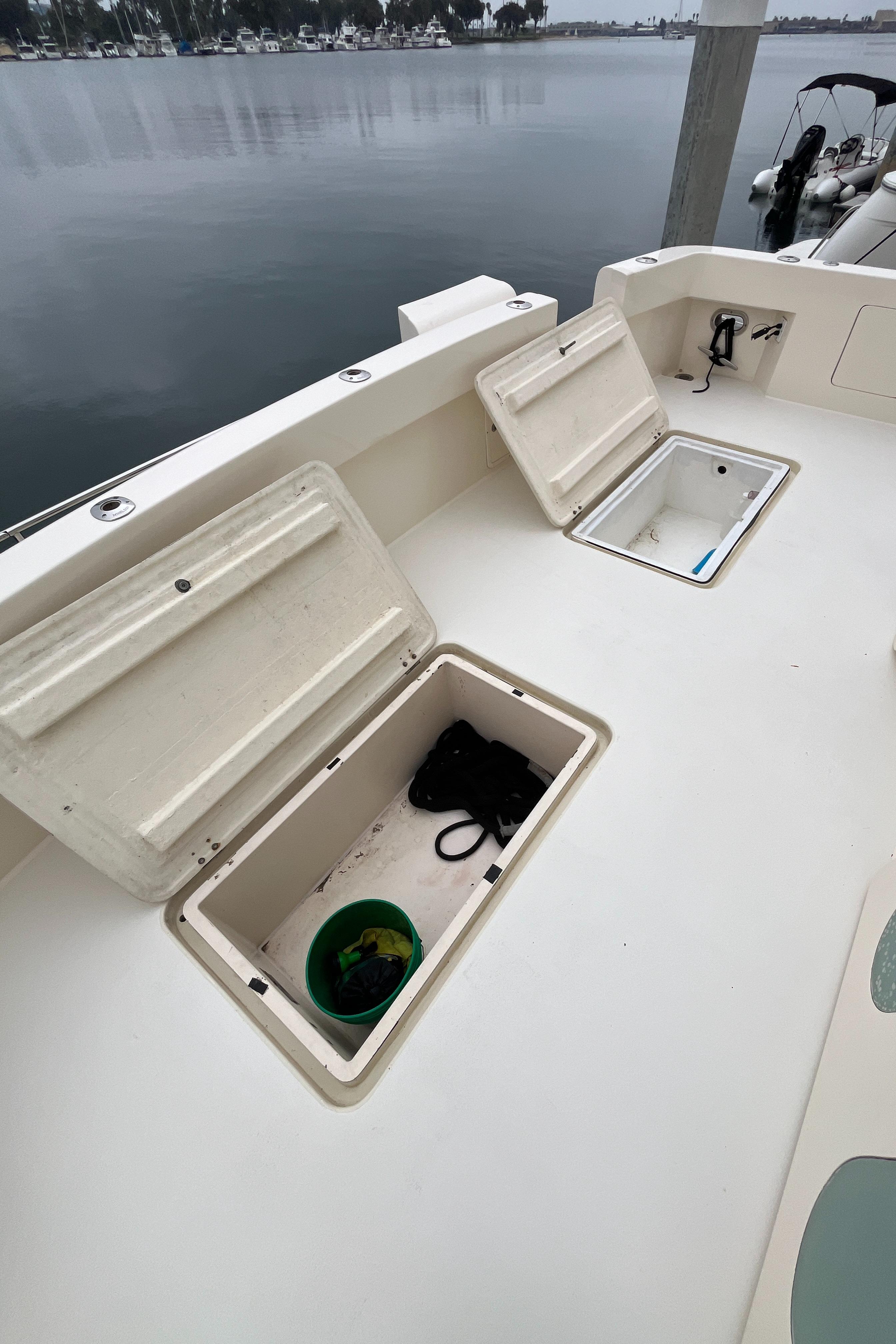 1999 Mikelson Long-Range Luxury Sportfisher deck with open storage compartments.